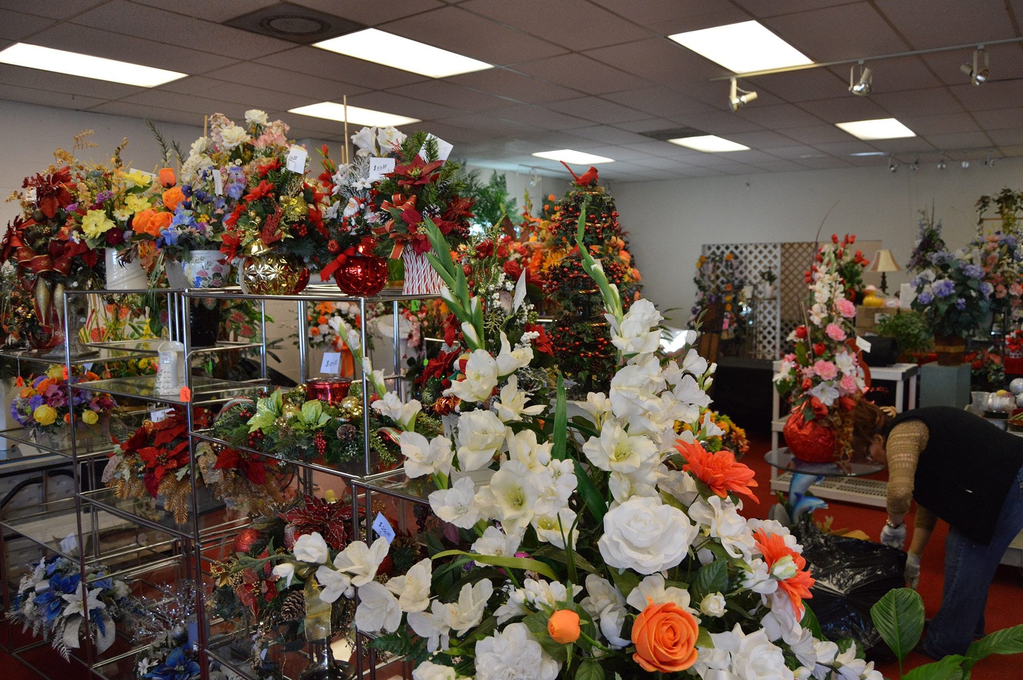 Rows of artificial flowers, all marked down 65 percent, decorate Shields Floral Boutique as a woman helps clear out the Hazel Dell shop. Tuesday is Carol Shields&#039; last day in business after 35 years.