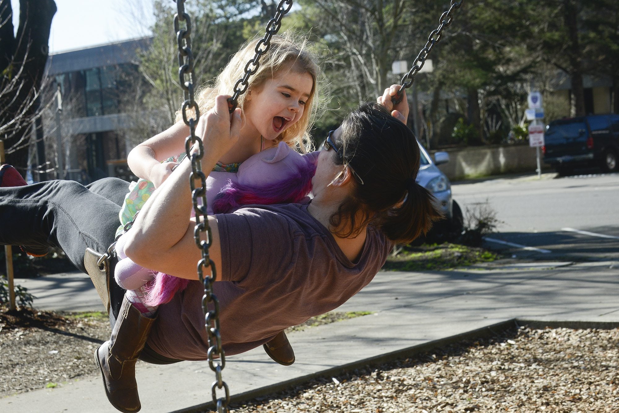 Jocelyn Leonard-Ulrich, 4, swings with her mother, Melissa Ulrich, on Monday at Esther Short Park in downtown Vancouver. Jocelyn has been learning how to use a swing set, her mother said.