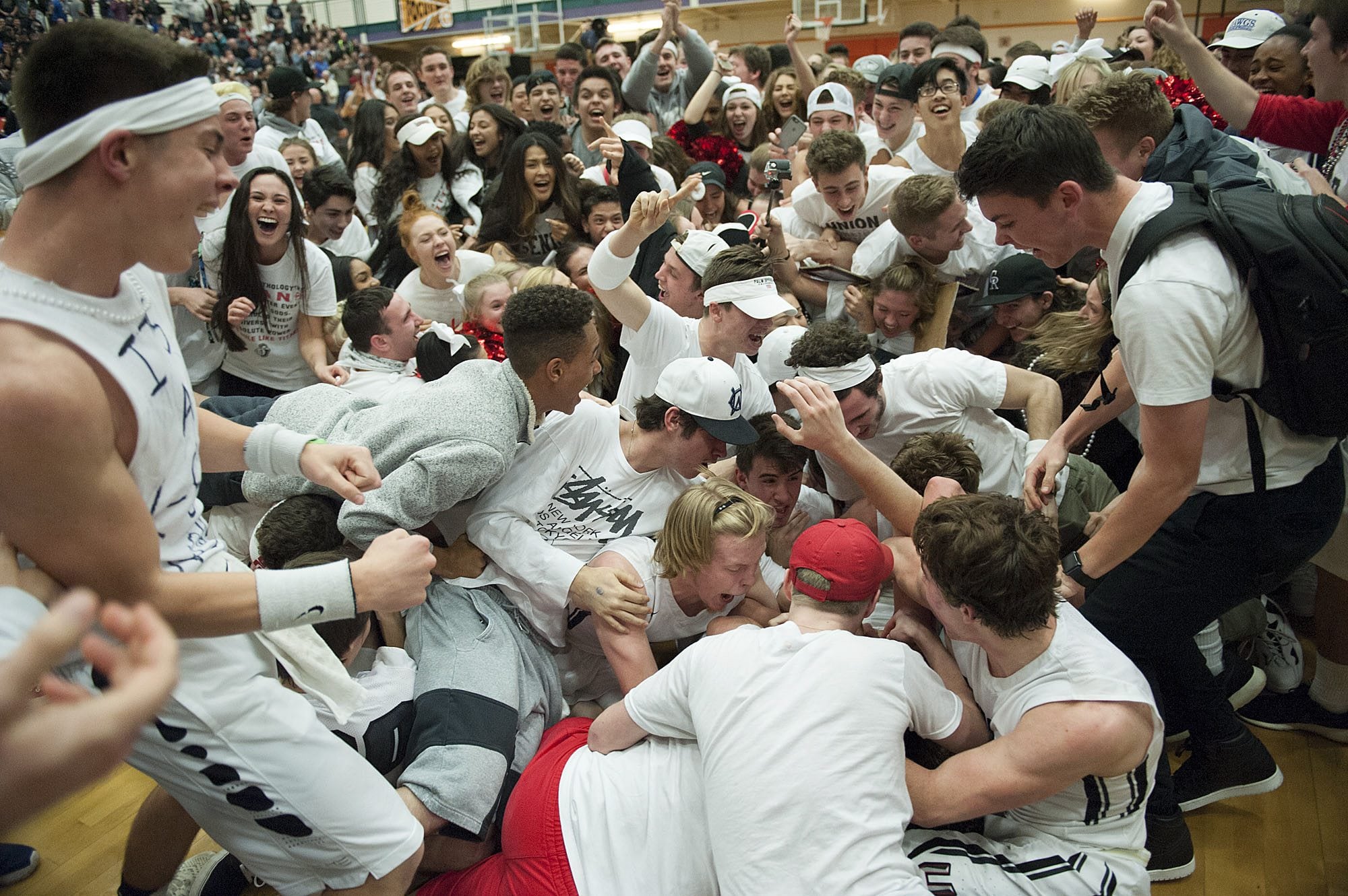Union fans rush the court after a last-second shot helped the team win against Bellarmine on Friday night, Feb. 26, 2016 at Battle Ground High School.