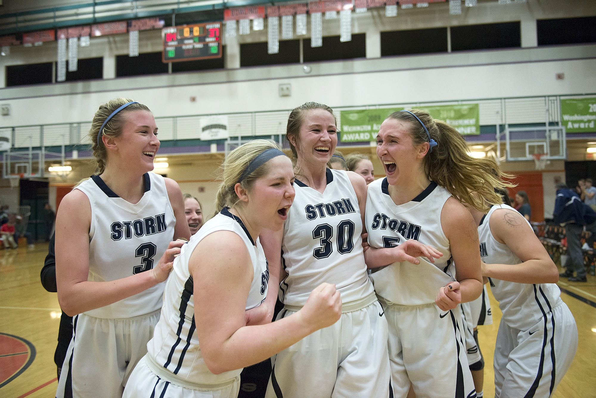 Members of the Skyview girls basketball team celebrate their win over Bellarmine on Friday night, Feb. 26, 2016 at Battle Ground High School.