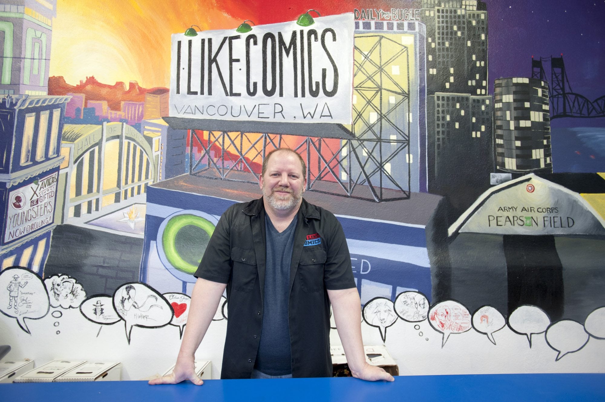 Chris Simons, owner of I like Comics, recently moved the store to larger quarters at 1715 Broadway in downtown Vancouver. The store&#039;s mural behind Simons was painted by some customers.