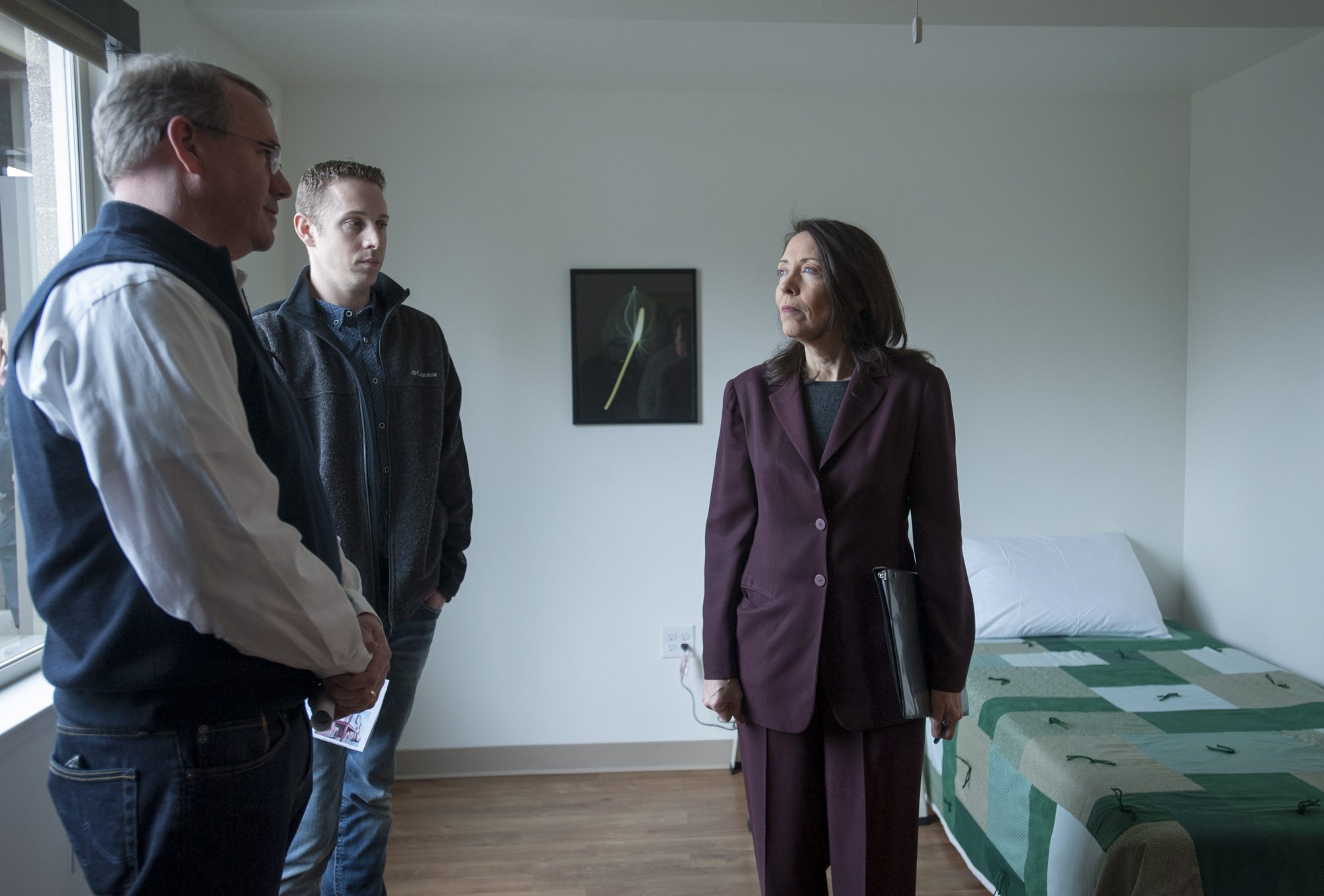 Sen. Maria Cantwell, D-Wash., talks to Dave Gunsul, President of Team Construction, left, and Ryan Dooley as she tours the soon-to-open Lincoln Place in downtown Vancouver, a 30-unit studio apartment complex for chronically homeless people.