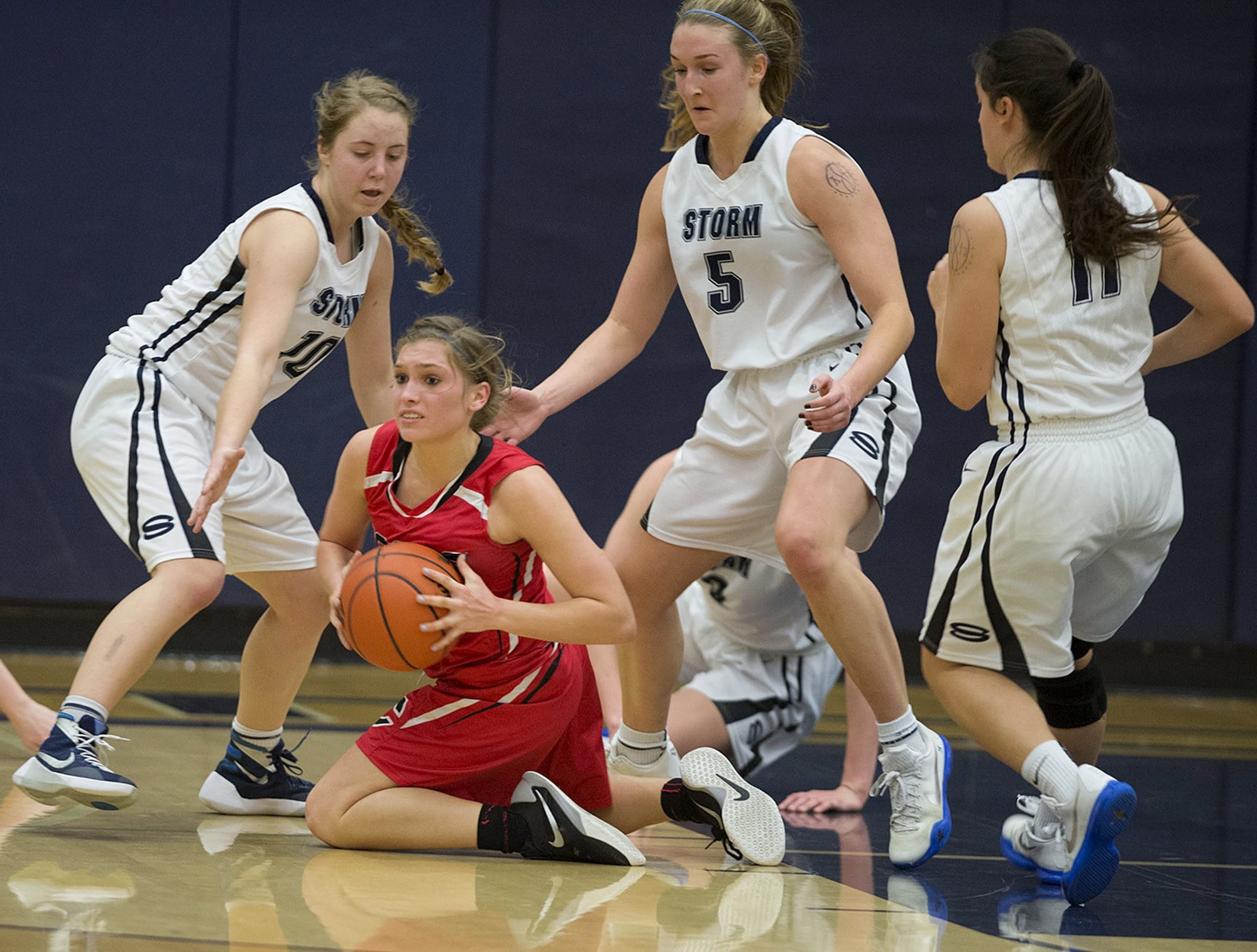 Camas' Meghan Finley, kneeling, recovers a loose ball in the fourth quarter as Skyview's Hanna Van Nortwick (10), Sydney Friauf (5) and Remington Riley (11) help out on the play Tuesday night, Feb. 2, 2016 at Skyview High School gym.
