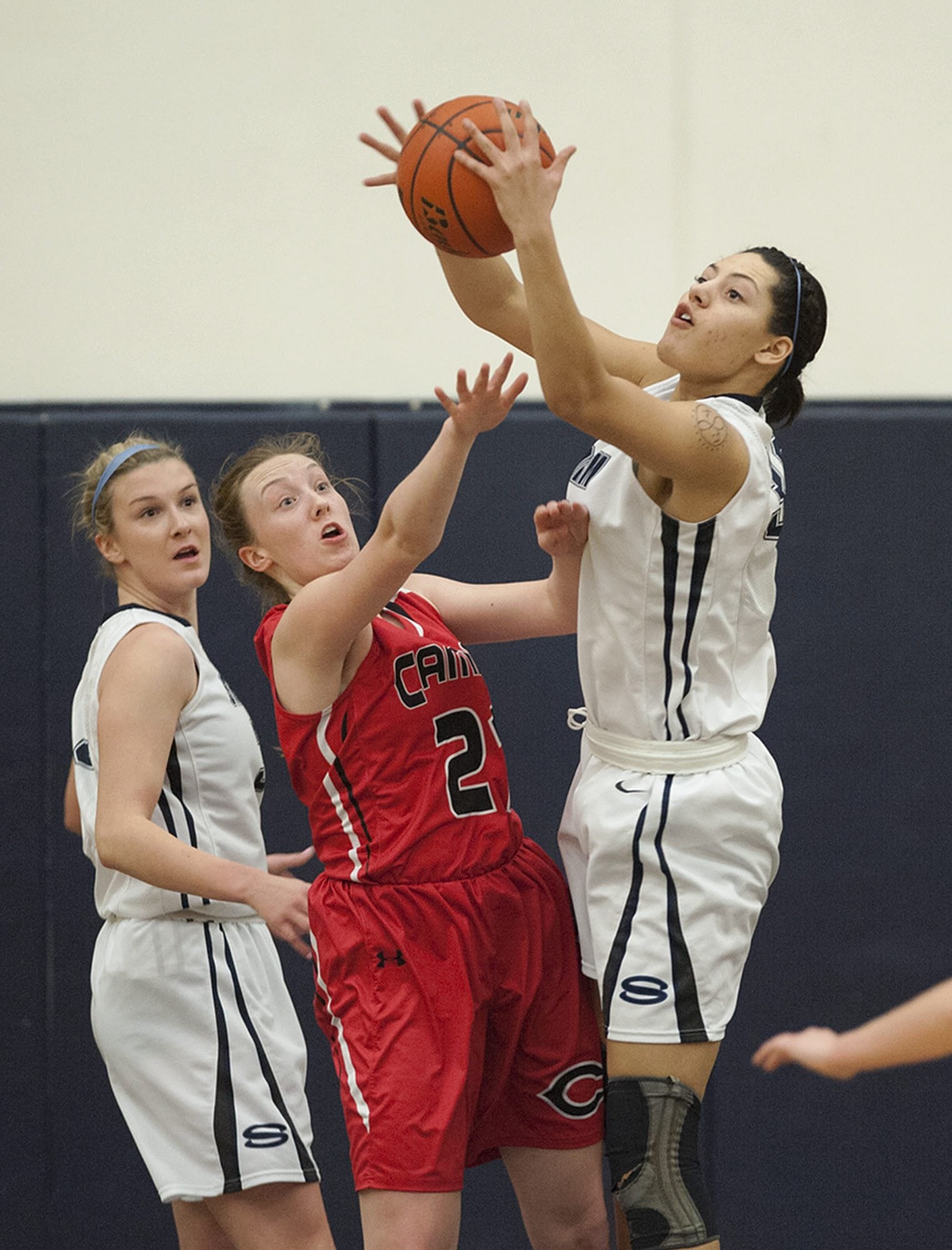 Skyview's Riley Friauf, left, looks on as Camas' Emma Jones (21) and Skyview's Maddie Lord, right, fight for a rebound in the first quarter Tuesday night, Feb. 2, 2016 at Skyview High School gym.