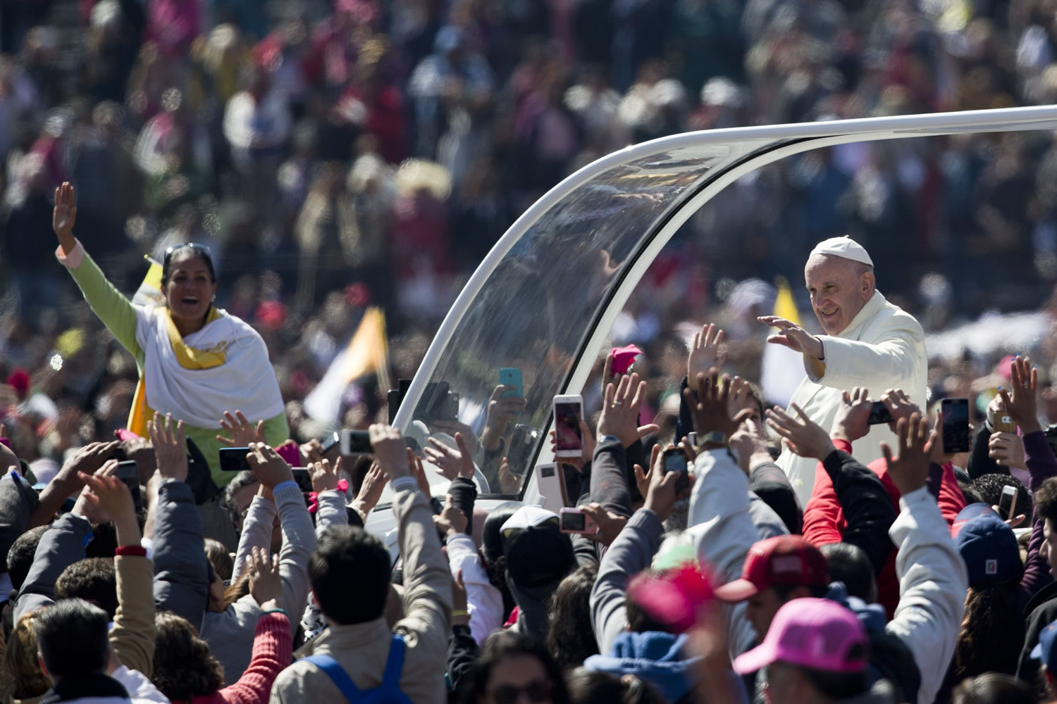 Pope Francis waves to the crowd, aboard the popemobile in Mexico City's main square, the Zocalo, Saturday, Feb. 13, 2016. Pope Francis kicks off his first trip to Mexico on Saturday with speeches to the country's political and ecclesial elites. The pontiff's five-day visit will include a very personal prayer at the Virgin of Guadalupe shrine.