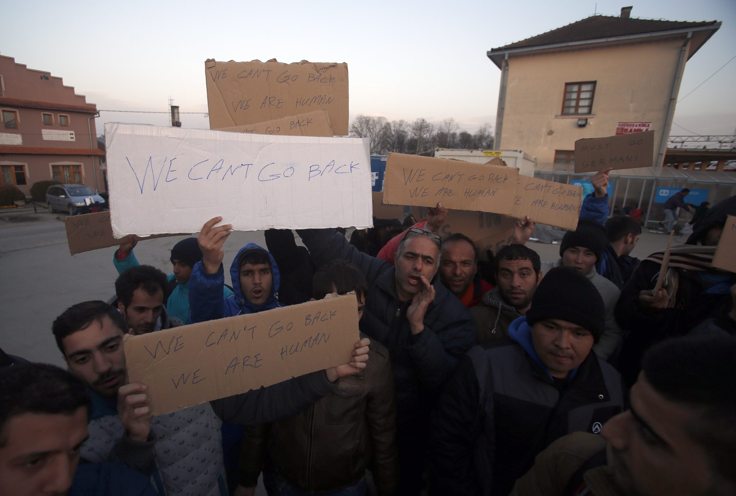Migrants shout slogans and protest Wednesday at the train station in Sid, west of Belgrade, Serbia. More than 200 people have been camping at a border train station after they were sent back to Serbia from Croatia amid tightened rules for migrants.