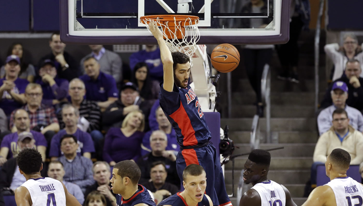 Arizona's Mark Tollefsen, top, dunks against Washington during the first half of an NCAA college basketball game Saturday, Feb. 6, 2016, in Seattle.
