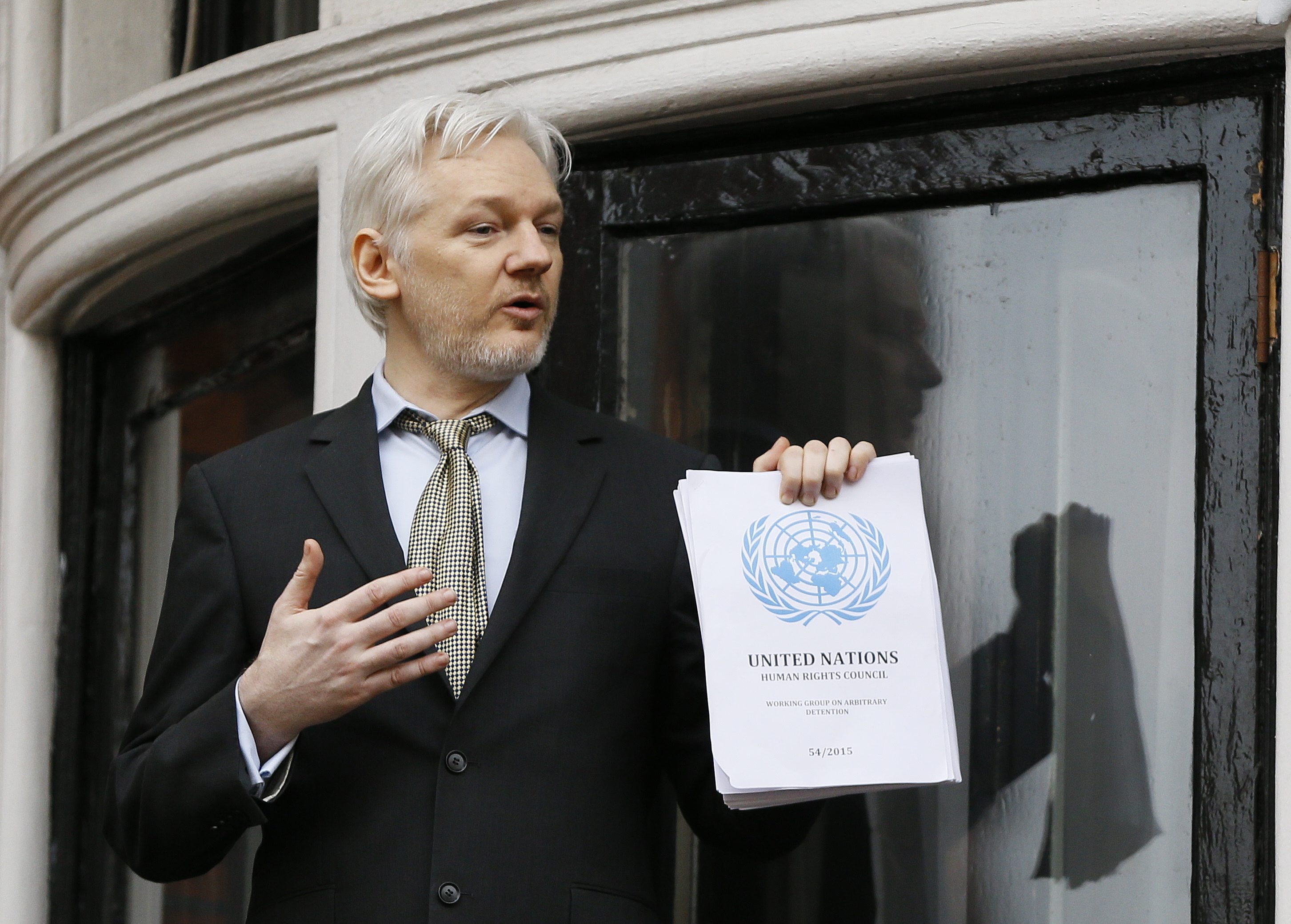 Wikileaks founder Julian Assange. holding a U.N. report, speaks Friday on the balcony of the Ecuadorean Embassy in London. A U.N. human rights panel says Assange, who has been squirreled away inside the Ecuadorean Embassy to avoid questioning by Swedish authorities about sexual misconduct allegations, has been "arbitrarily detained" by Britain and Sweden since December 2010. The U.N. Working Group on Arbitrary Detention said his detention should end and he should be entitled to compensation.