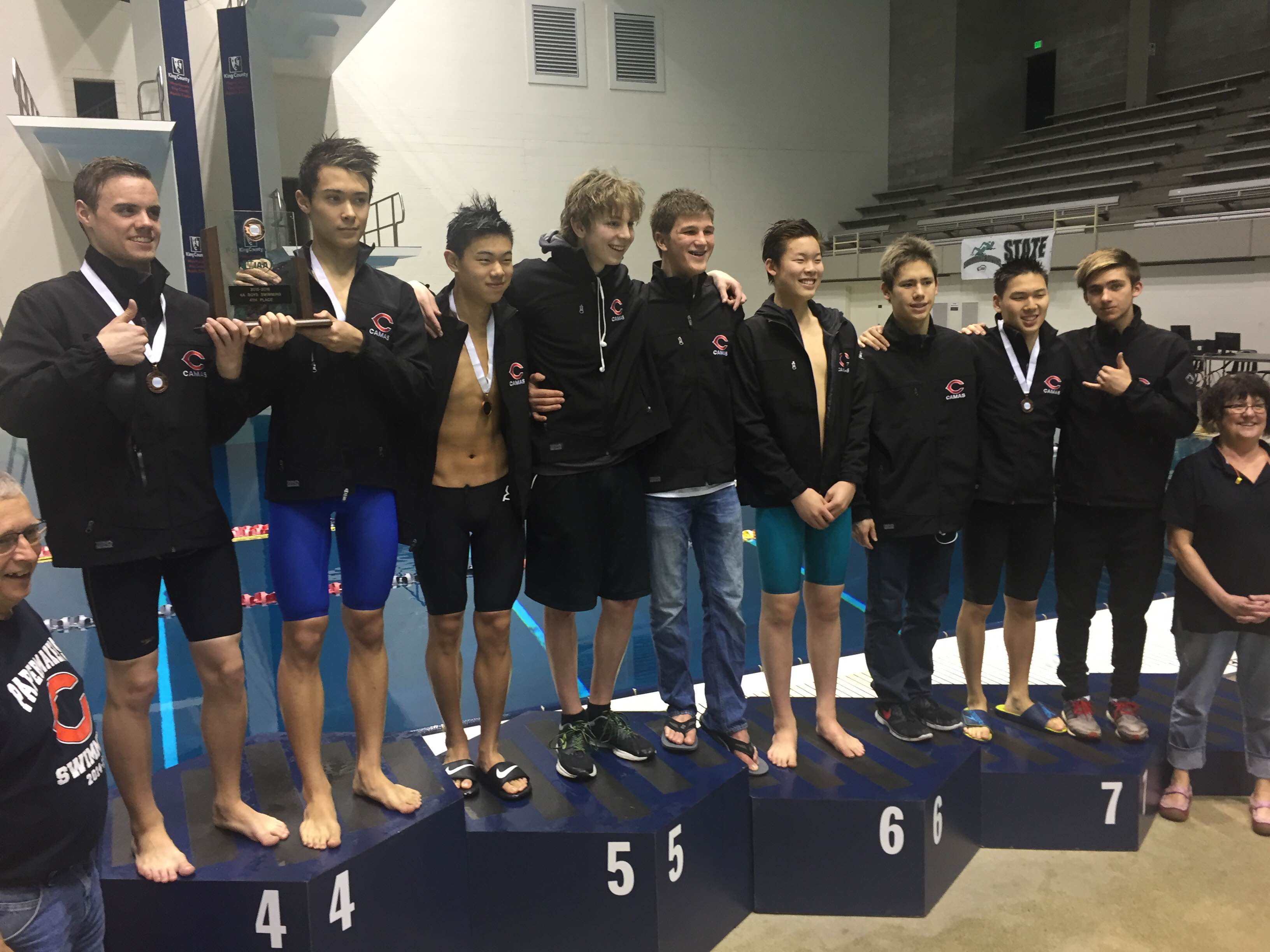 Members of the Camas swim team on the podium after receiving their fourth-place team medals at the 4A state meet at Federal Way on Saturday, Feb. 20, 2016.