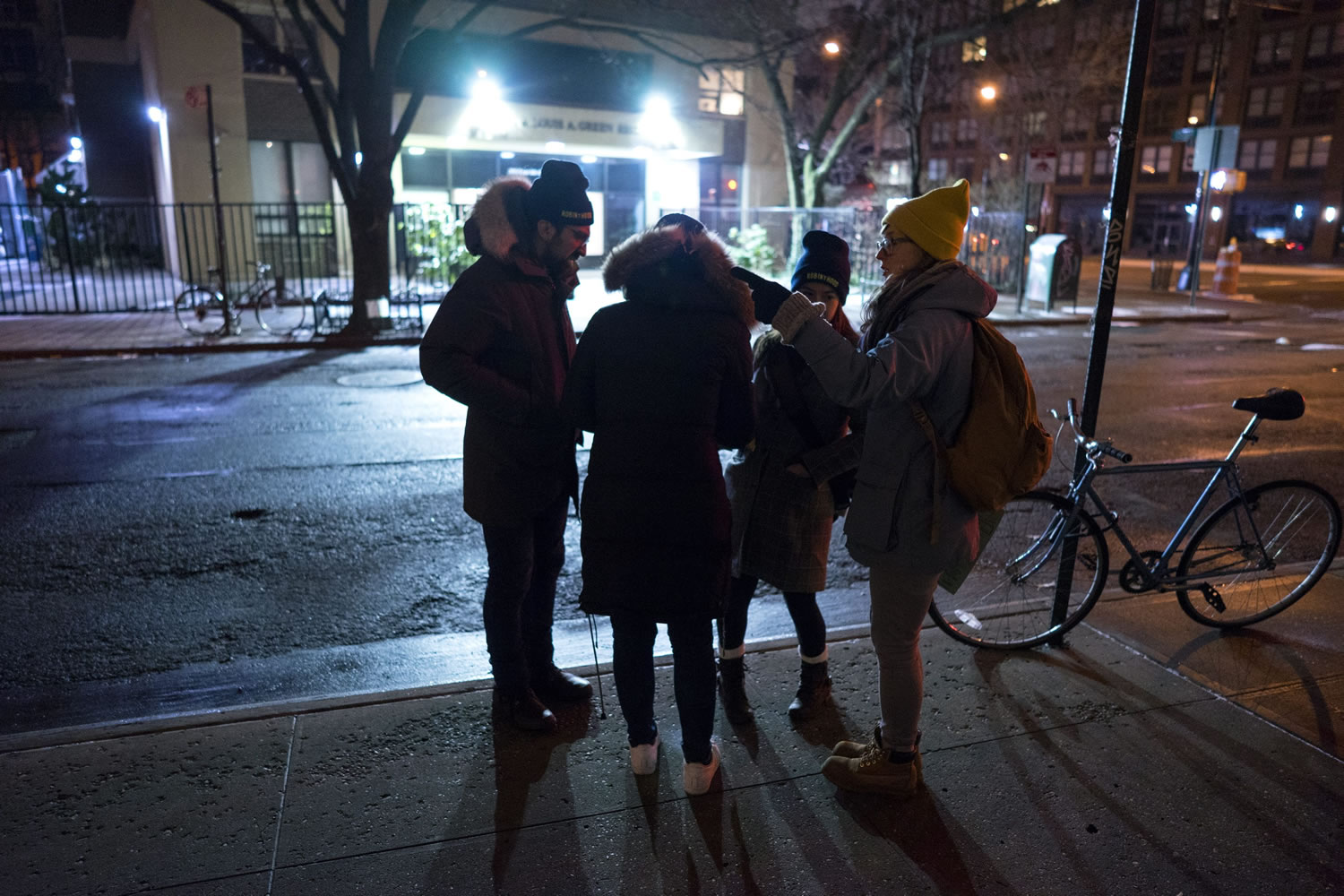 From left, Edward Casabian, Victoria Parker, Alexis Sypek and Ashley Treni, all from New York and working with The Robin Hood Foundation, an organization that helps the poor, plan their route as they take part in a count and survey of homeless persons on the streets of New York early Tuesday. Hundreds of people fanned out across the city to conduct the survey just after midnight.