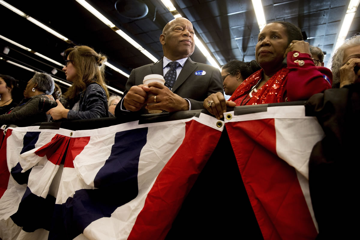 Reps. John Lewis, D-Ga., center, and Sheila Jackson-Lee, D-Texas, right, wait at Democratic presidential candidate Hillary Clinton&#039;s caucus night rally at Drake University in Des Moines, Iowa, on Feb. 1.