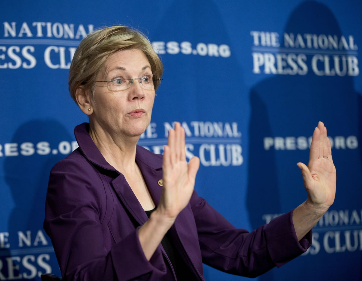 Sen. Elizabeth Warren, D-Mass. gestures before speaking at the National Press Club in Washington.