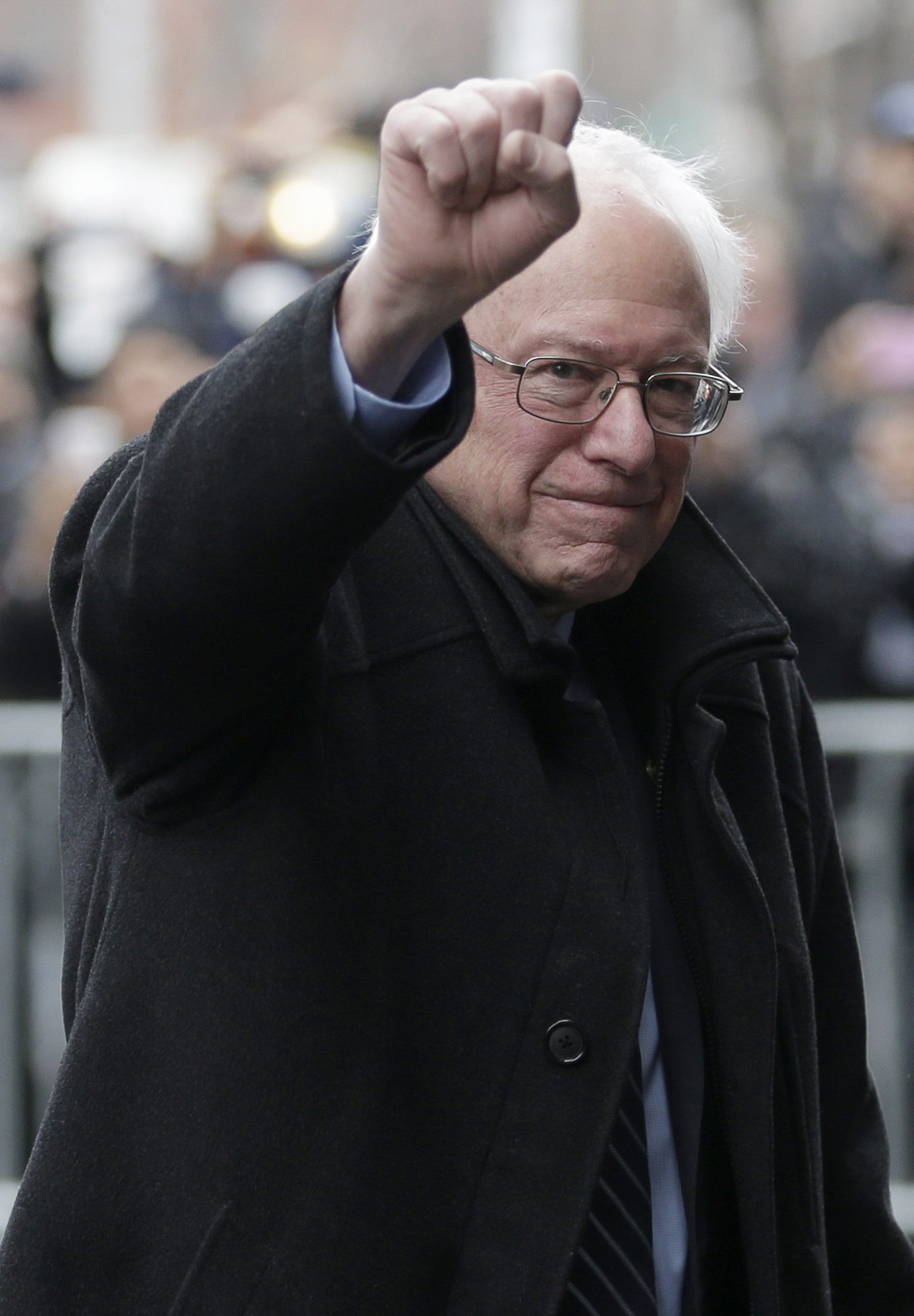 Democratic presidential candidate Sen. Bernie Sanders, I-Vt., raises a fist as he arrives for a breakfast meeting with Al Sharpton at Sylvia&#039;s Restaurant on Wednesday in the Harlem neighborhood of New York.