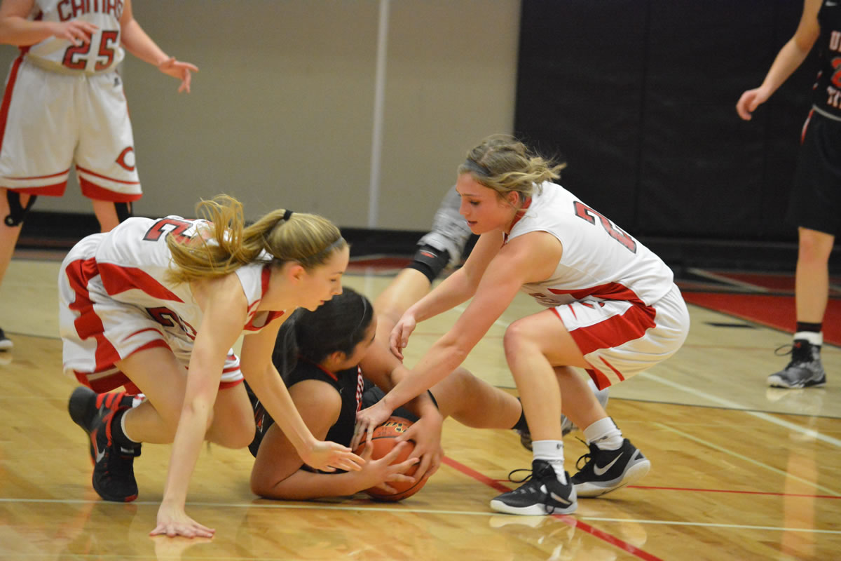 Madison Freemon, left, and Meghan Finley of Camas battle for the ball with Union's Kili Anderson during a 4A District 4 Girls Basketball Tournament game Thursday at Camas (Micah Rice/The Columbian).