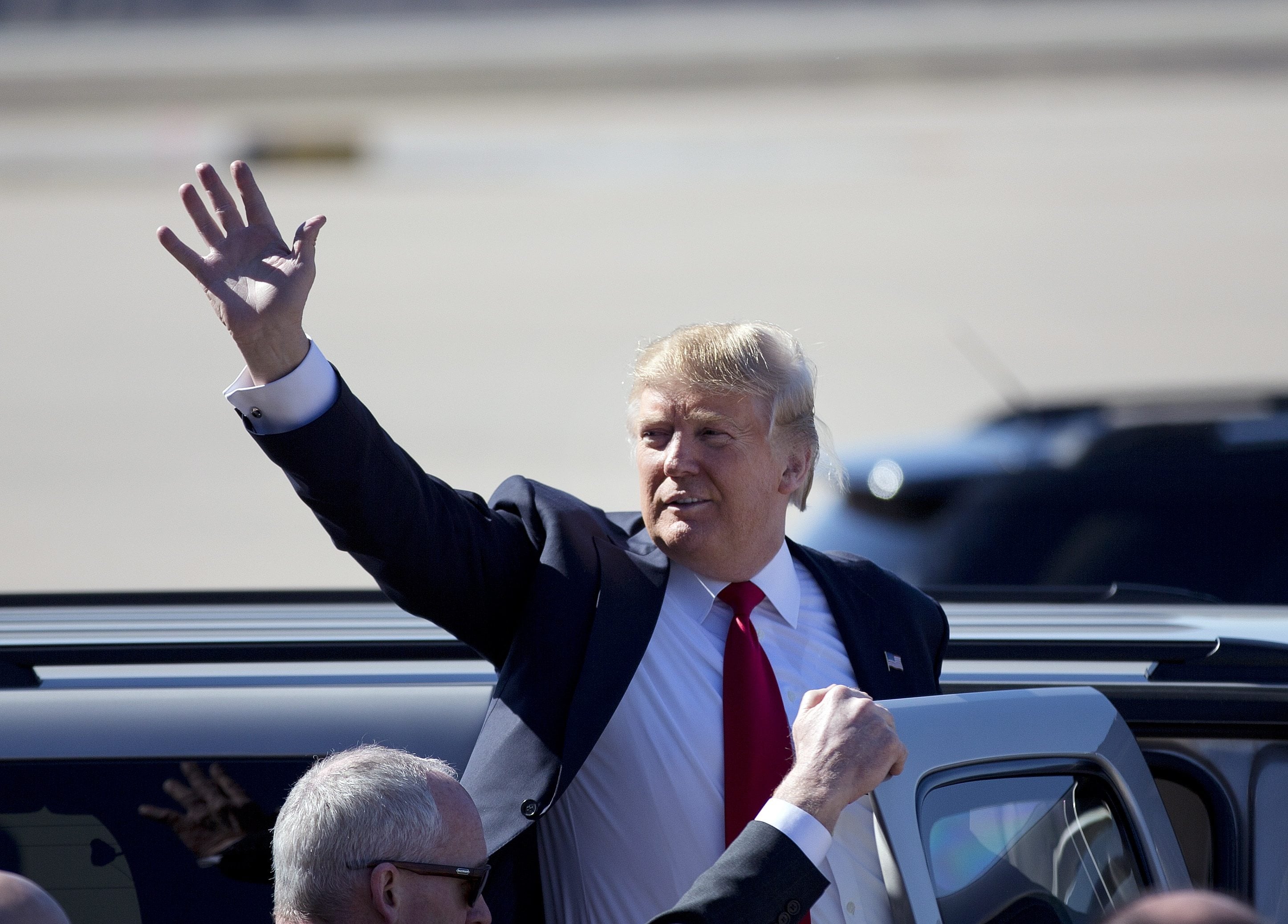 Republican presidential candidate Donald Trump waves as he leaves a rally Saturday in Bentonville, Ark.