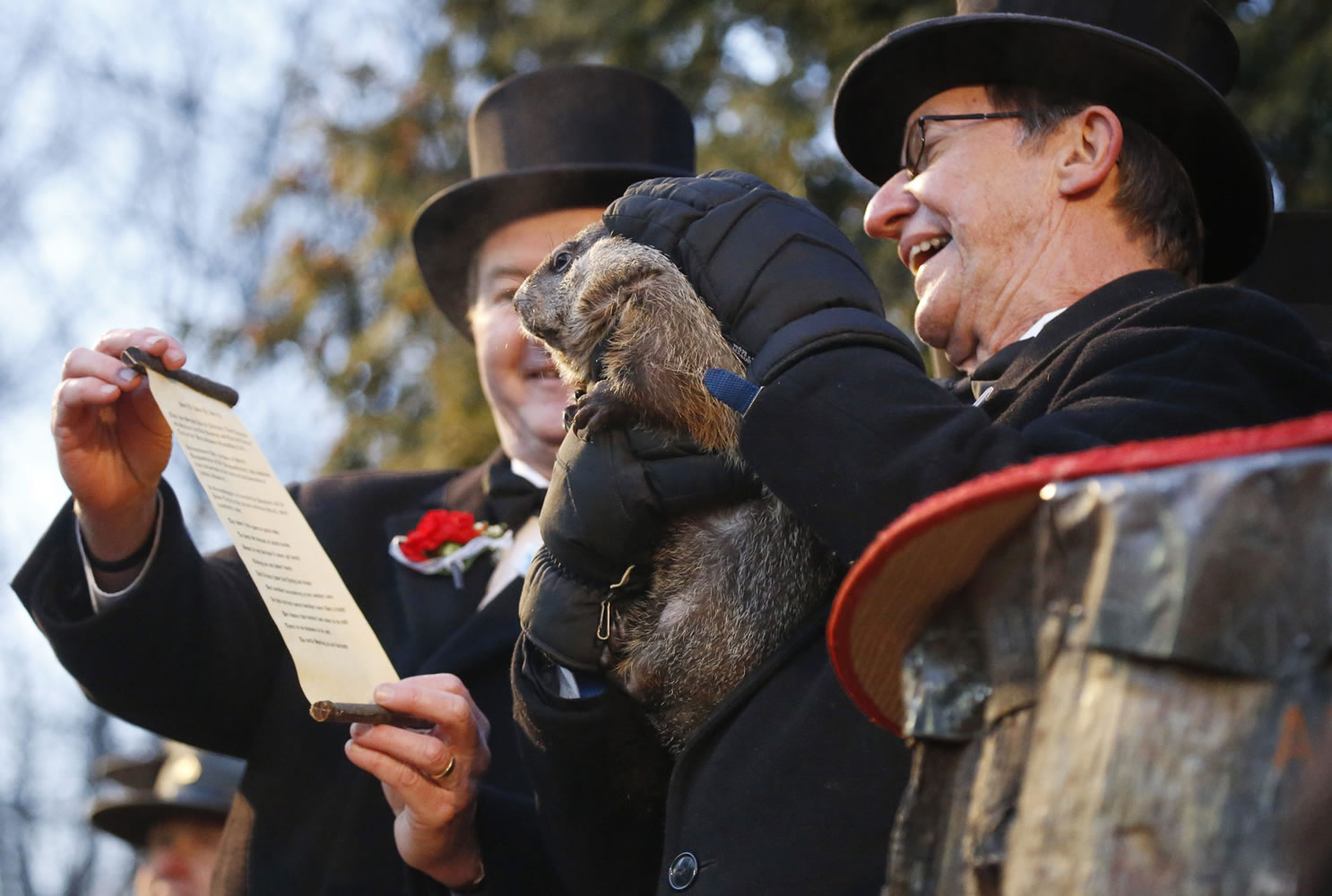 Co-handler Ron Ploucha, right, holds Punxsutawney Phil as Jeff Lundy, vice president of the Inner Circle of the Punxsutawney Groundhog Club, holds the scroll Tuesday during the annual celebration of Groundhog Day on Gobbler&#039;s Knob in Punxsutawney, Pa.