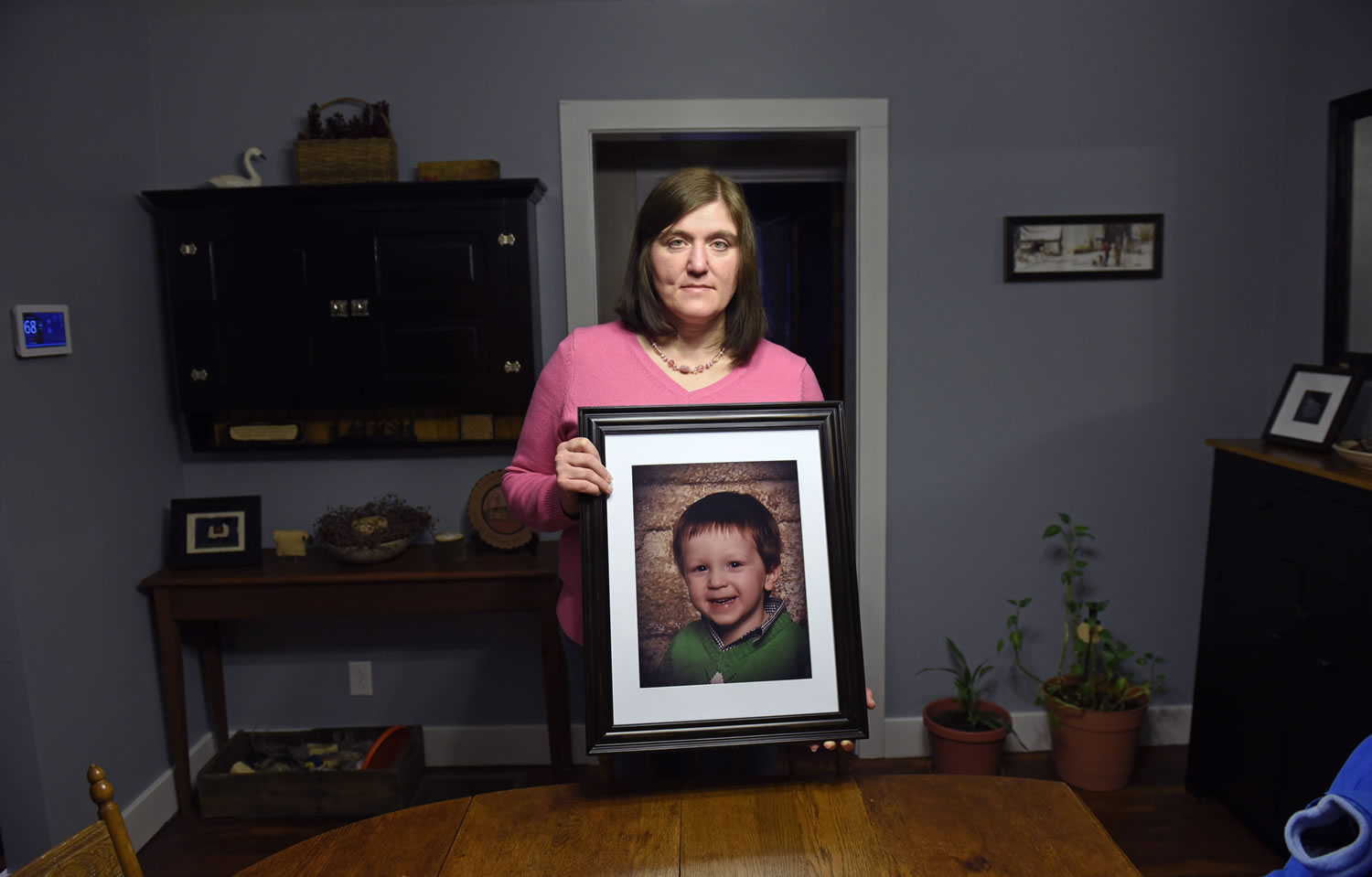 Hollie Ayers holds a photograph of her late son, Michael, 2, at her home in Bedford, Pa. Michael was shot and killed in front of her by her abusive ex-husband in 2013. Ayers was shot in the face and the leg, and her ex-husband killed himself after the rampage.