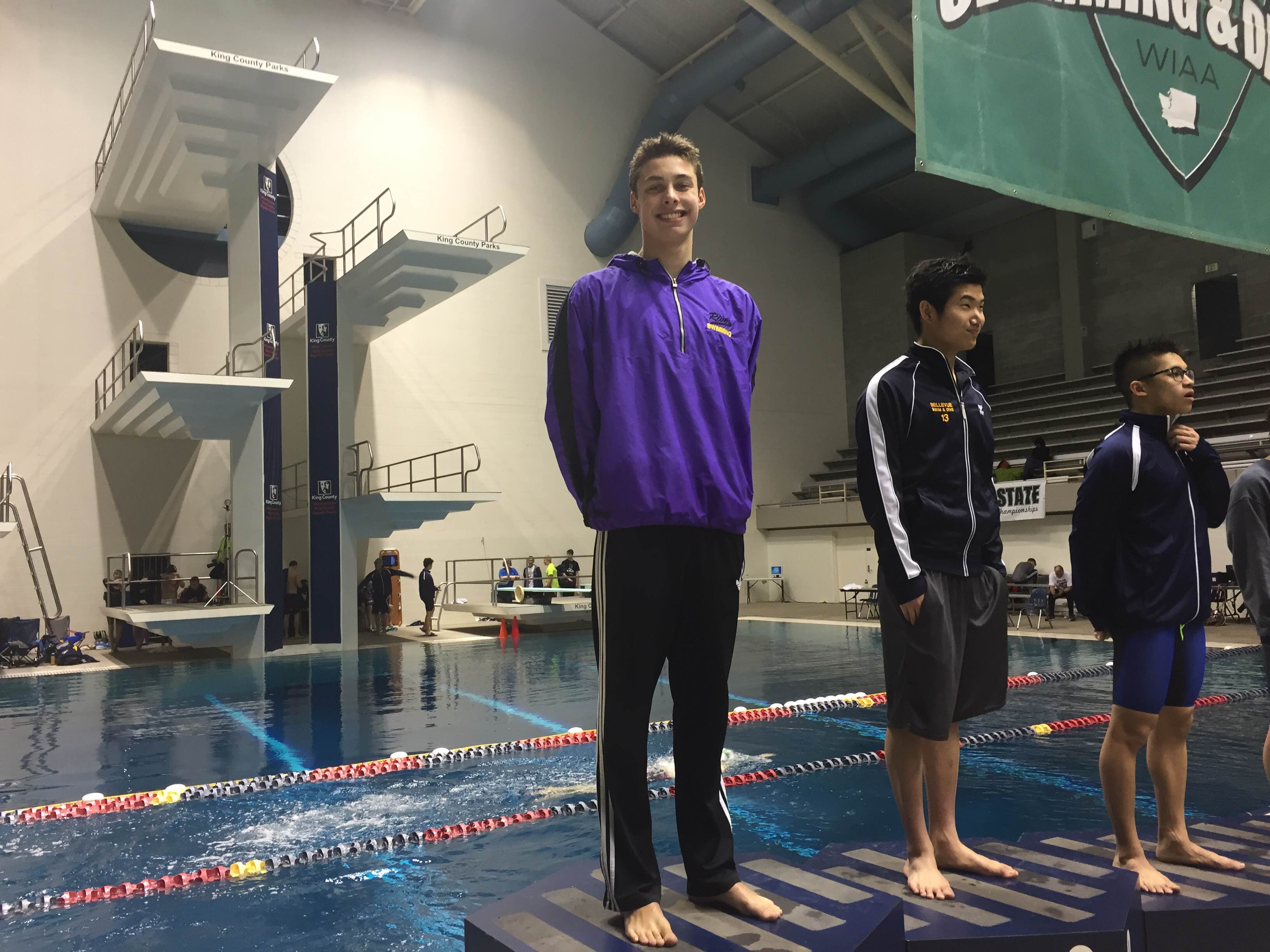 Columbia River's Josh Bottelberghe stands atop the podium after winning the 3A state title in the 100-yard breaststroke on Saturday, Feb. 20, 2016, at Federal Way.