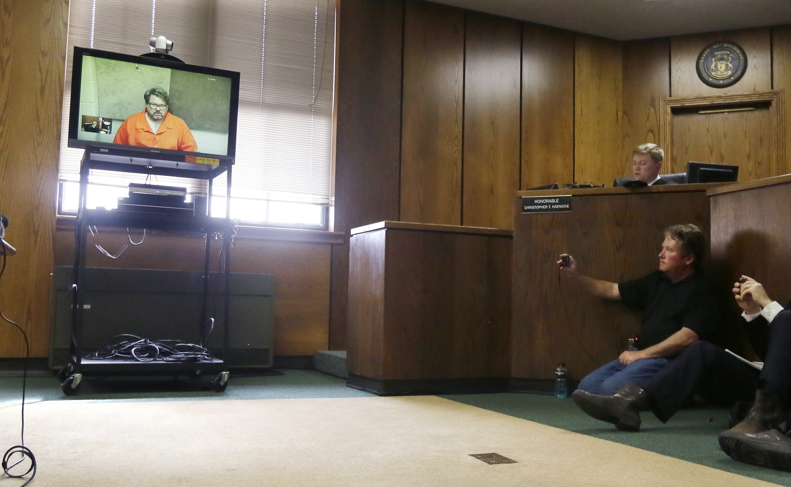 Jason Dalton is arraigned via video Monday before Judge Christopher T. Haenicke in Kalamazoo, Mich. Dalton is charged with six counts of murder and two counts of attempted murder in a series of random shootings in western Michigan.