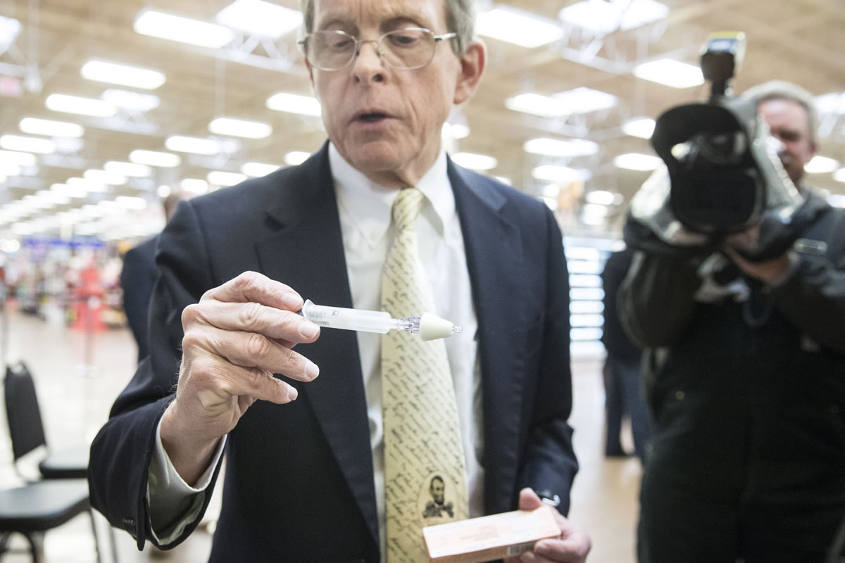 Ohio Attorney General Mike DeWine handles a Naloxone nasal injector during a news conference at the Oakley Kroger Marketplace store to announce the supermarket chain&#039;s decision to offer the opioid overdose reversal medicine without a prescription Friday in Cincinnati. Naloxone is routinely carried by fire-rescue crews, which use it thousands of times a year in Ohio to revive overdose victims. Kroger, based in Cincinnati, has 2,774 supermarkets and multi-department stores in 35 states and the District of Columbia.