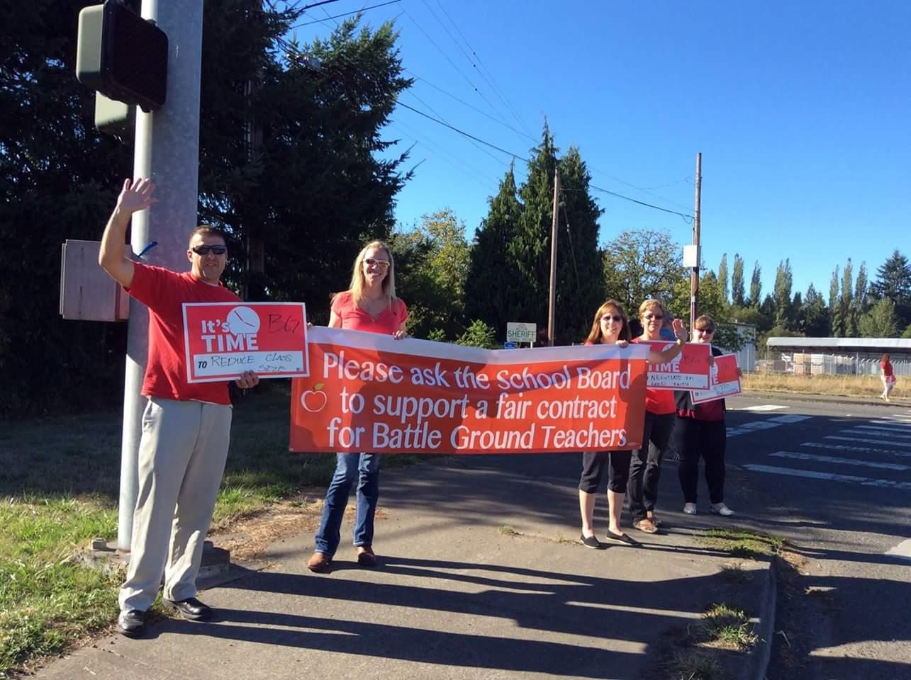 Battle Ground teachers, who have been without a contract since Sept. 1, wave banners in support of a fair contract.