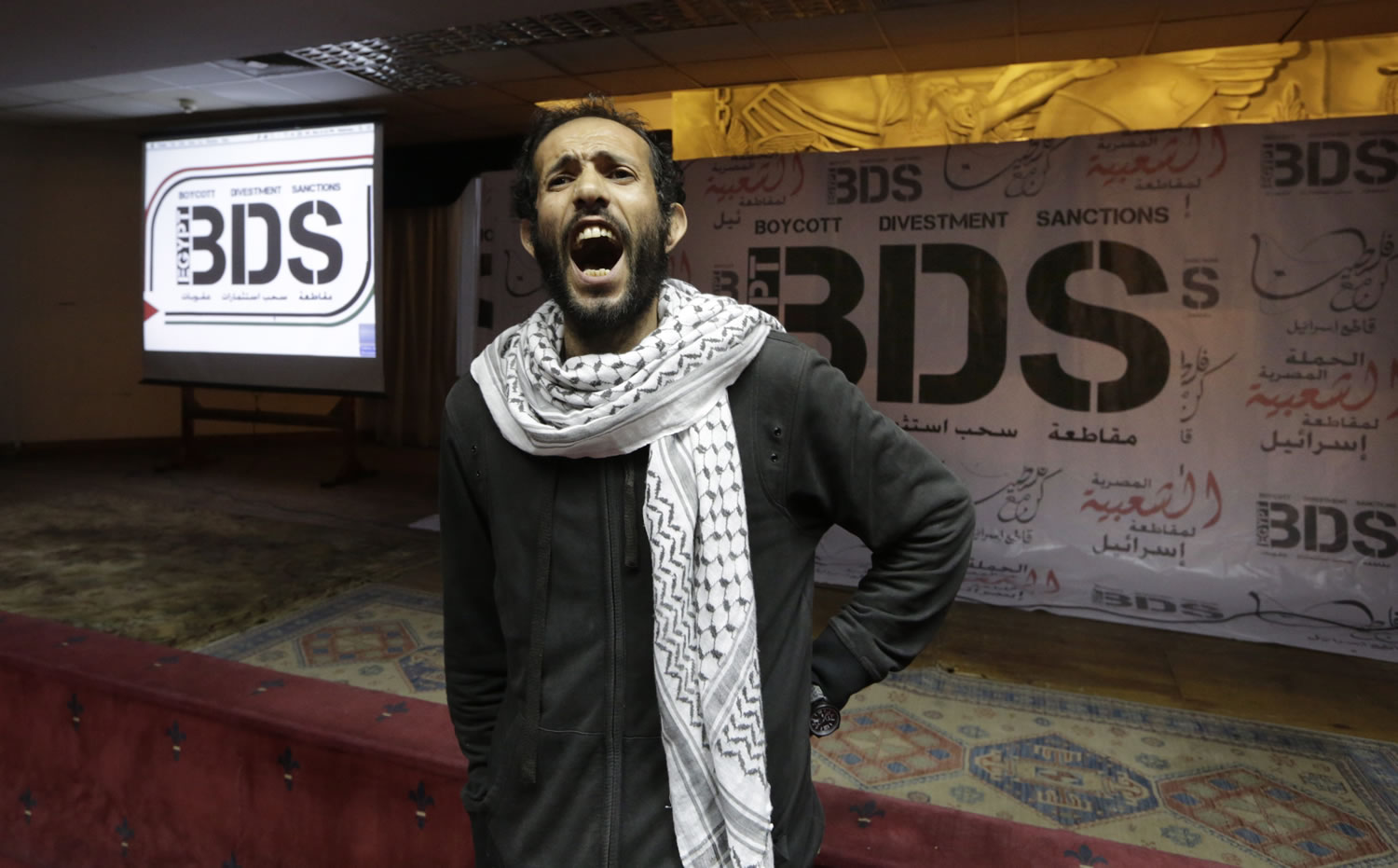 An Egyptian man shouts anti-Israeli slogans in front of banners with the Boycott, Divestment and Sanctions logo during the launch of the Egyptian campaign that urges boycott, divestment and sanctions against Israel and Israeli-made goods, at the Egyptian Journalists&#039; Syndicate in Cairo, Egypt. Israel is using its world-leading expertise in cyber security to take on the growing threat posed by the global pro-Palestinian movement to boycott Israel.