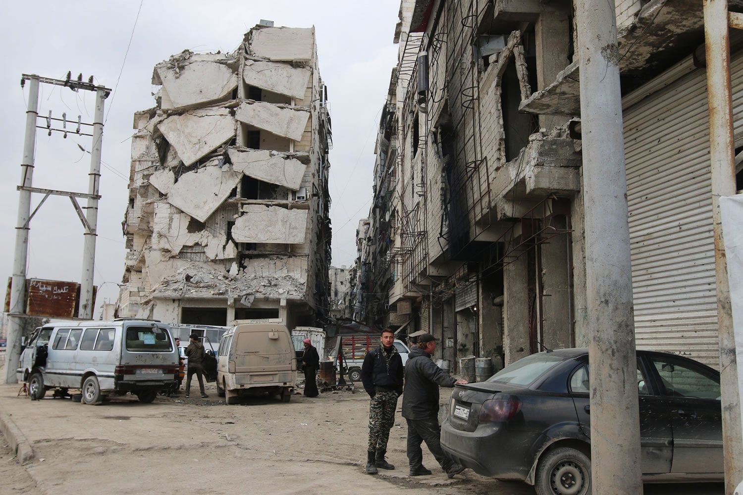 In this Thursday, Feb. 11, 2016 photo, a building is seen with heavy damage in Aleppo, Syria. The fighting around Syria's largest city of Aleppo has brought government forces closer to the Turkish border than at any point in recent years, routing rebels from key areas and creating a humanitarian disaster as tens of thousands of people flee.