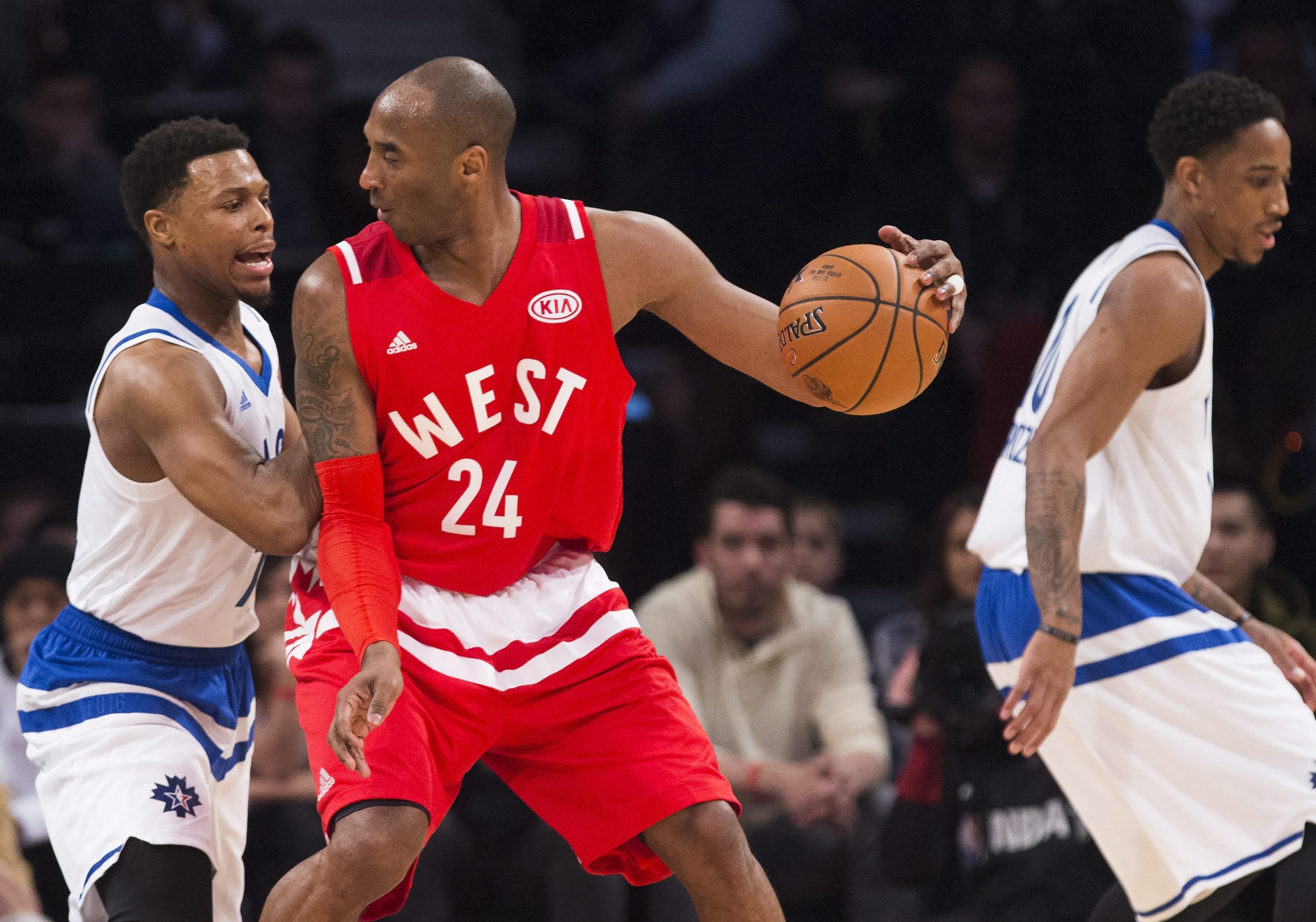 Western Conference's Kobe Bryant, of the Los Angeles Lakers (24) tries to move the ball past Eastern Conference's Kyle Lowry, of the Toronto Raptors, left, during the first half of the NBA all-star basketball game, Sunday, Feb. 14, 2016 in Toronto.