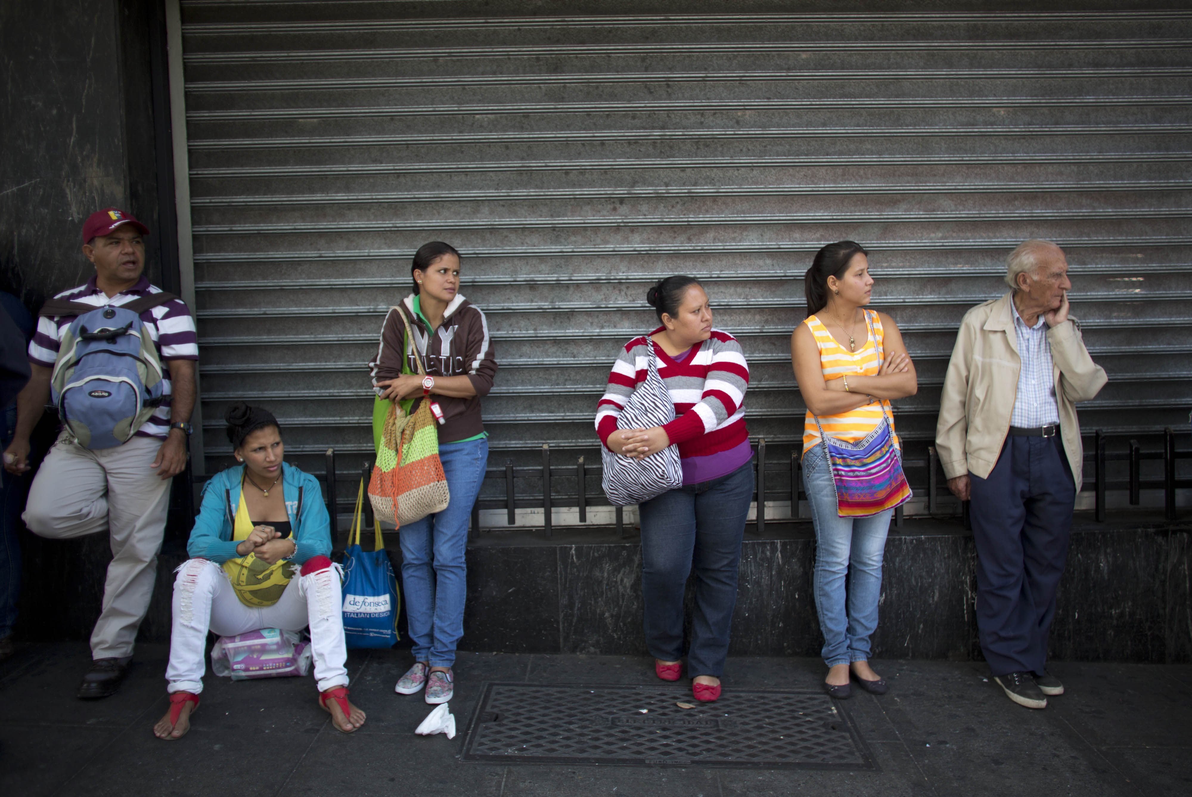 People wait in line Wednesday to buy groceries at government-regulated prices in Caracas, Venezuela. Venezuela&#039;s government earns 95 percent of its export income from oil, and its economy was already unraveling before the plunge in oil prices. Long lines for food and other scarce goods are commonplace.