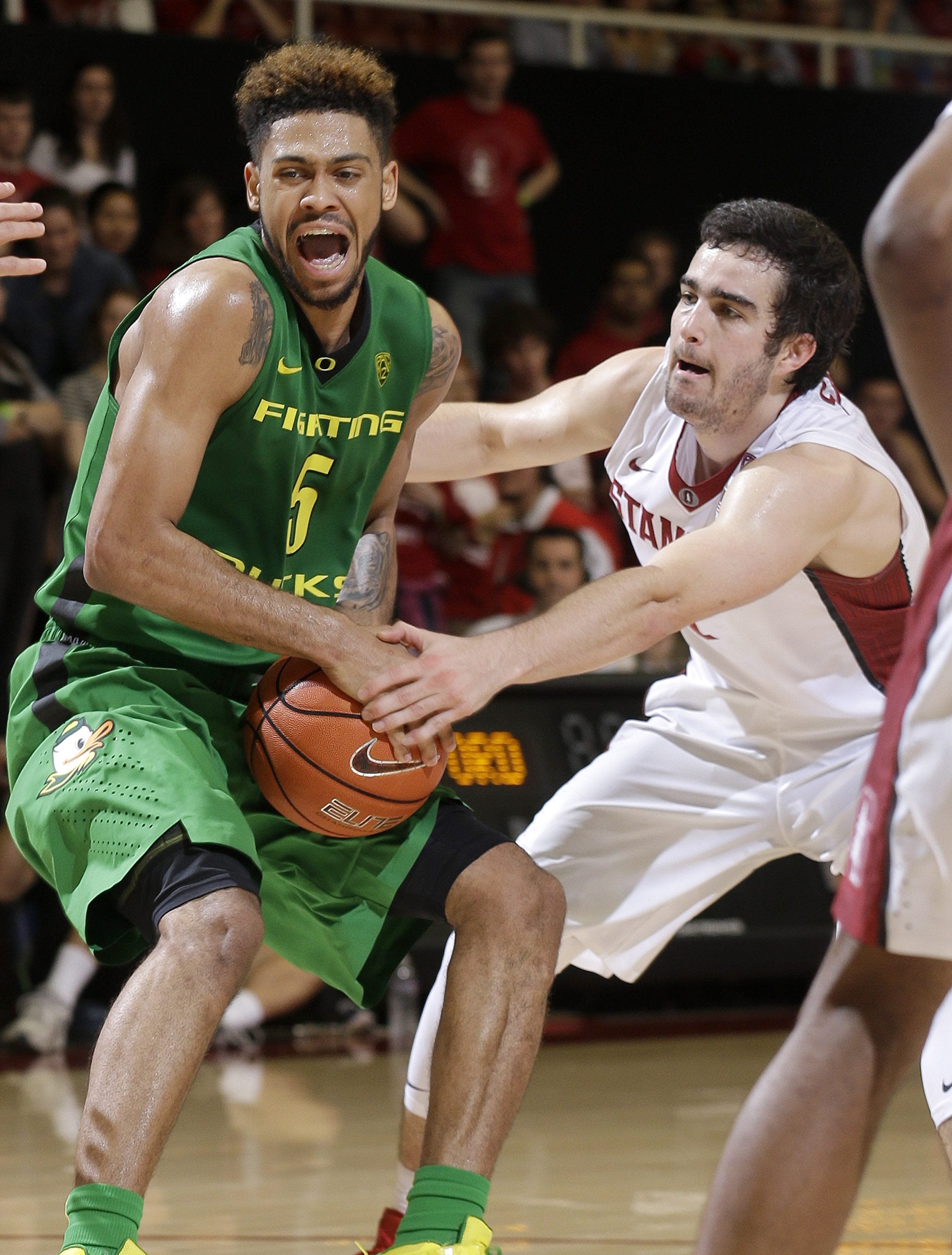 Oregon's Tyler Dorsey (5) is defended by Stanford's Christian Sanders during the first half of an NCAA college basketball game in Stanford, Calif., Saturday, Feb. 13, 2016.