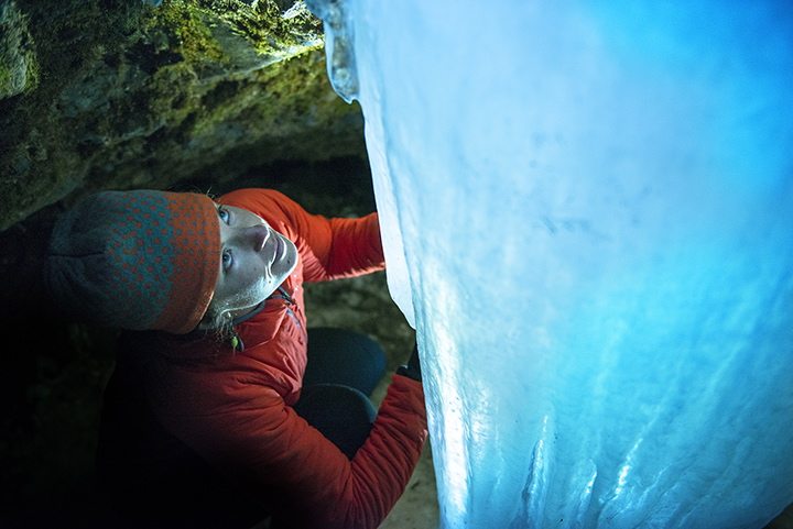 In this Tuesday, Feb. 9, 2016 photo, Erin McCleary, of Bozeman, Mont., explores an ice cave behind Grotto Falls on a cross-country ski trip to Hyalite Canyon in Bozeman, Mont.
