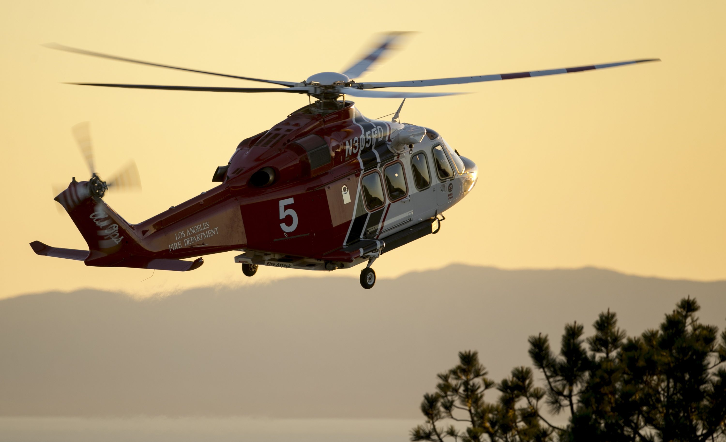 A Los Angeles County Fire helicopter gets ready to land at Angels Gate Park as rescue boats continue to search for wreckage from two small planes that collided in midair and plunged into the ocean off of Los Angeles harbor Friday. The planes apparently went into the water about 2 miles outside the harbor entrance, U.S. Coast Guard and other officials said.