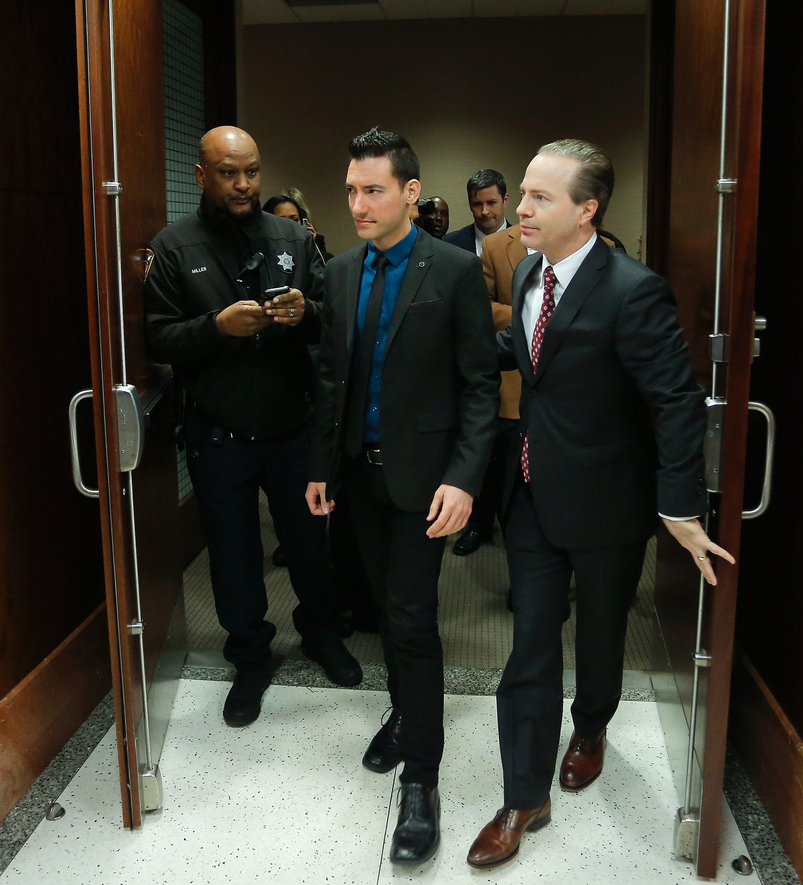David Daleiden, left, one of the two anti-abortion activists indicted last week, leaves the courtroom with attorney Jared Woodfill after turning himself in to authorities Thursday in Houston. Daleiden and Sandra Merritt are charged with tampering with a governmental record, a felony punishable by up to 20 years in prison.