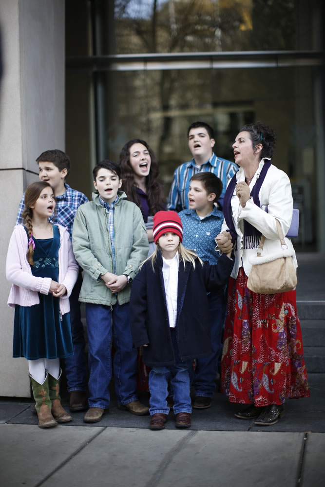 Odalis Sharp and some of her children sing outside the federal courthouse Wednesday in Portland. The Sharps were there to support Ammon Bundy and others who have pleaded not guilty to charges related to the armed takeover of an Oregon wildlife refuge.