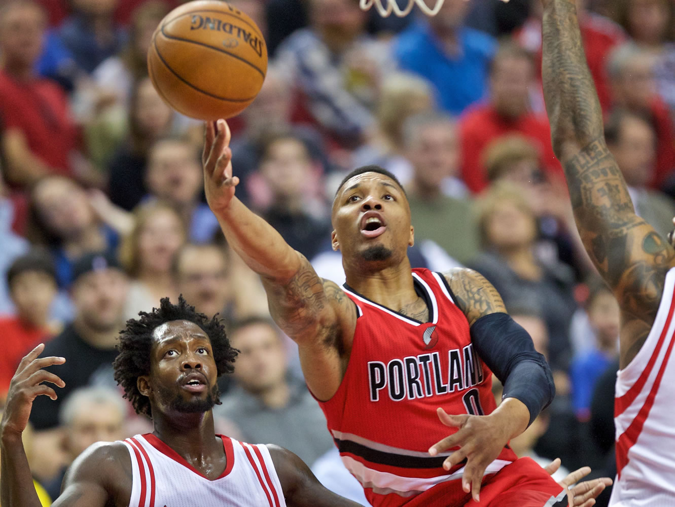 Portland Trail Blazers guard Damian Lillard shoots over Houston Rockets guard Patrick Beverley, left, during the second half of an NBA basketball game in Portland, Ore., Thursday, Feb. 25, 2016.