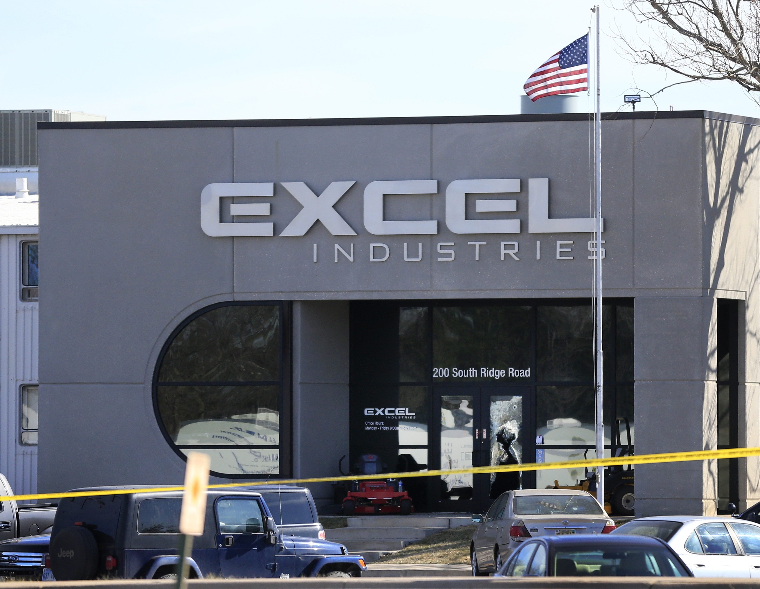 Shattered glass and bullet holes are seen Friday at the front door of Excel Industries in Hesston, Kan. Harvey County Sheriff T. Walton identified the gunman as Cedric Ford, who stormed into the factory where he worked and shot several people. It was the at least the fourth workplace shooting in the U.S. in the past 12 months.