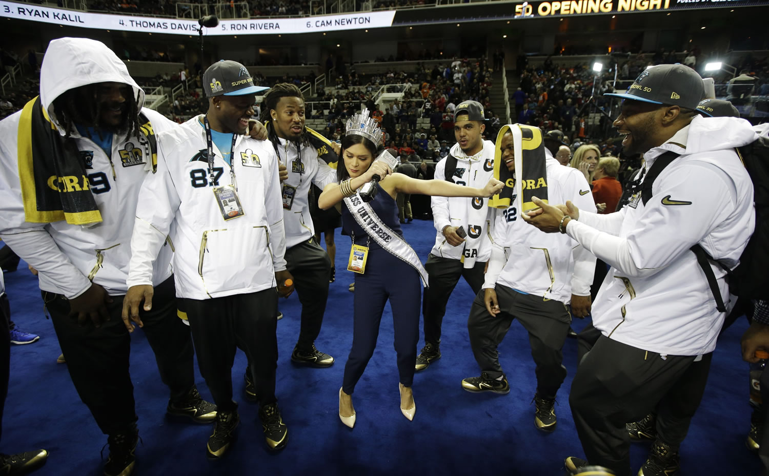 Miss Universe Pia Alonzo Wurtzbach dances with Carolina Panthers players during Opening Night for the NFL Super Bowl 50 football game Monday, Feb. 1, 2016, in San Jose, Calif.