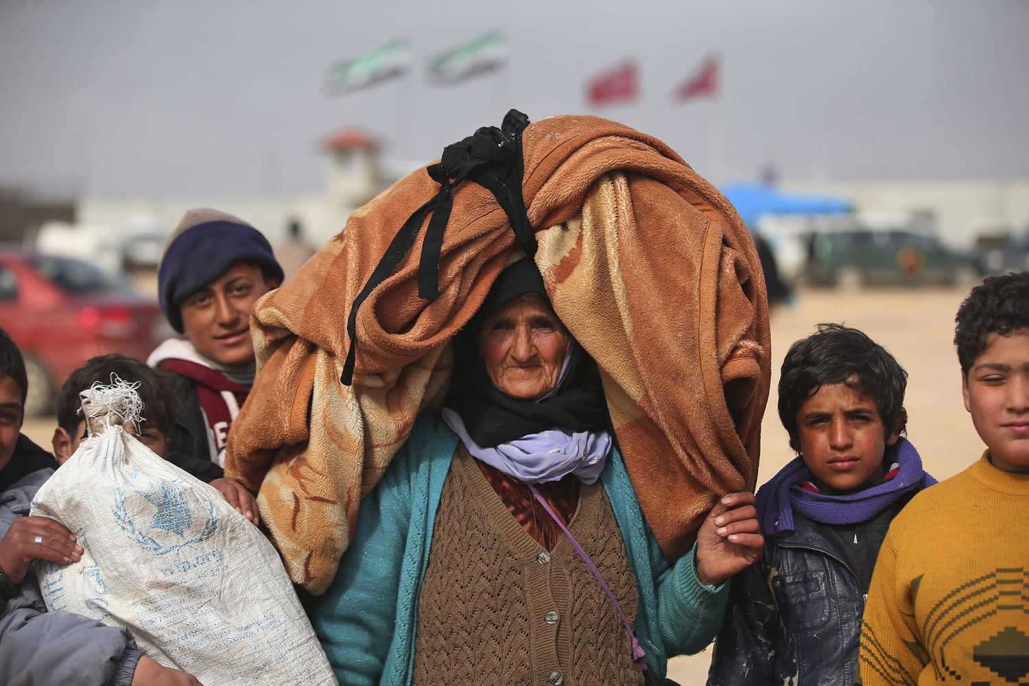 Syrians head toward the Bab al-Salam border crossing with Turkey on Saturday in Syria.