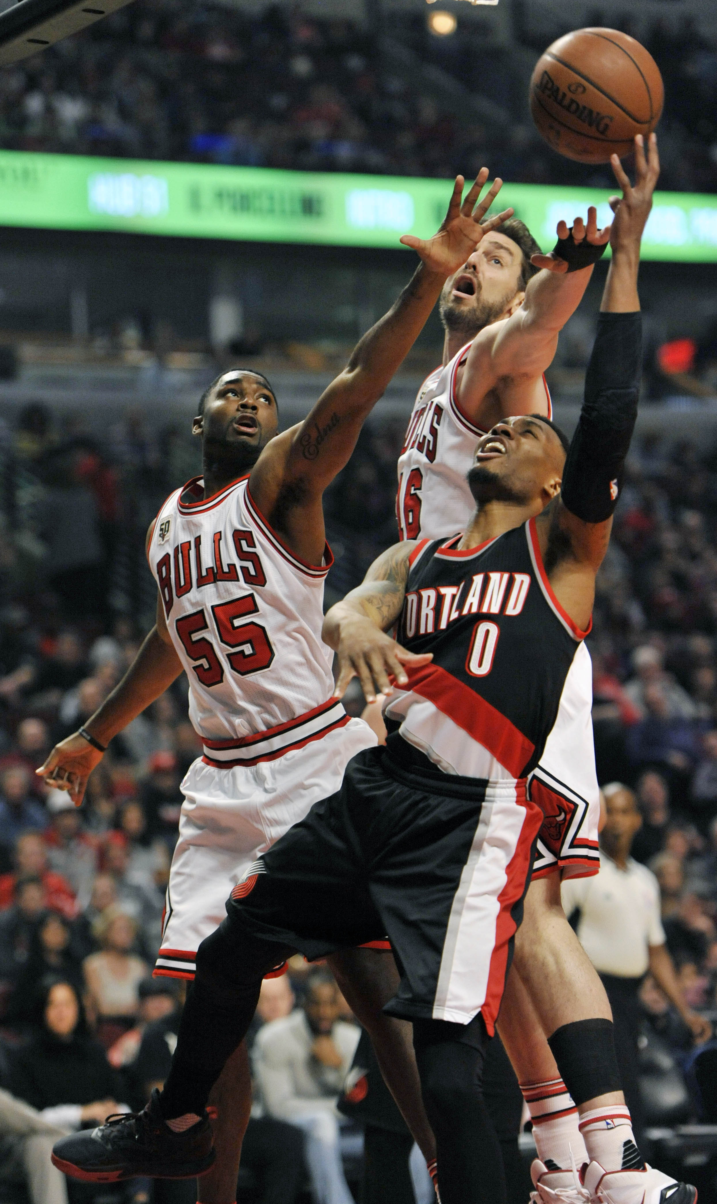 Portland Trail Blazers' Damian Lillard (0) goes up for a shot against Chicago Bulls' Pau Gasol (16) and E'Twaun Moore (55) during the first half of an NBA basketball game Saturday, Feb. 27, 2016, in Chicago.