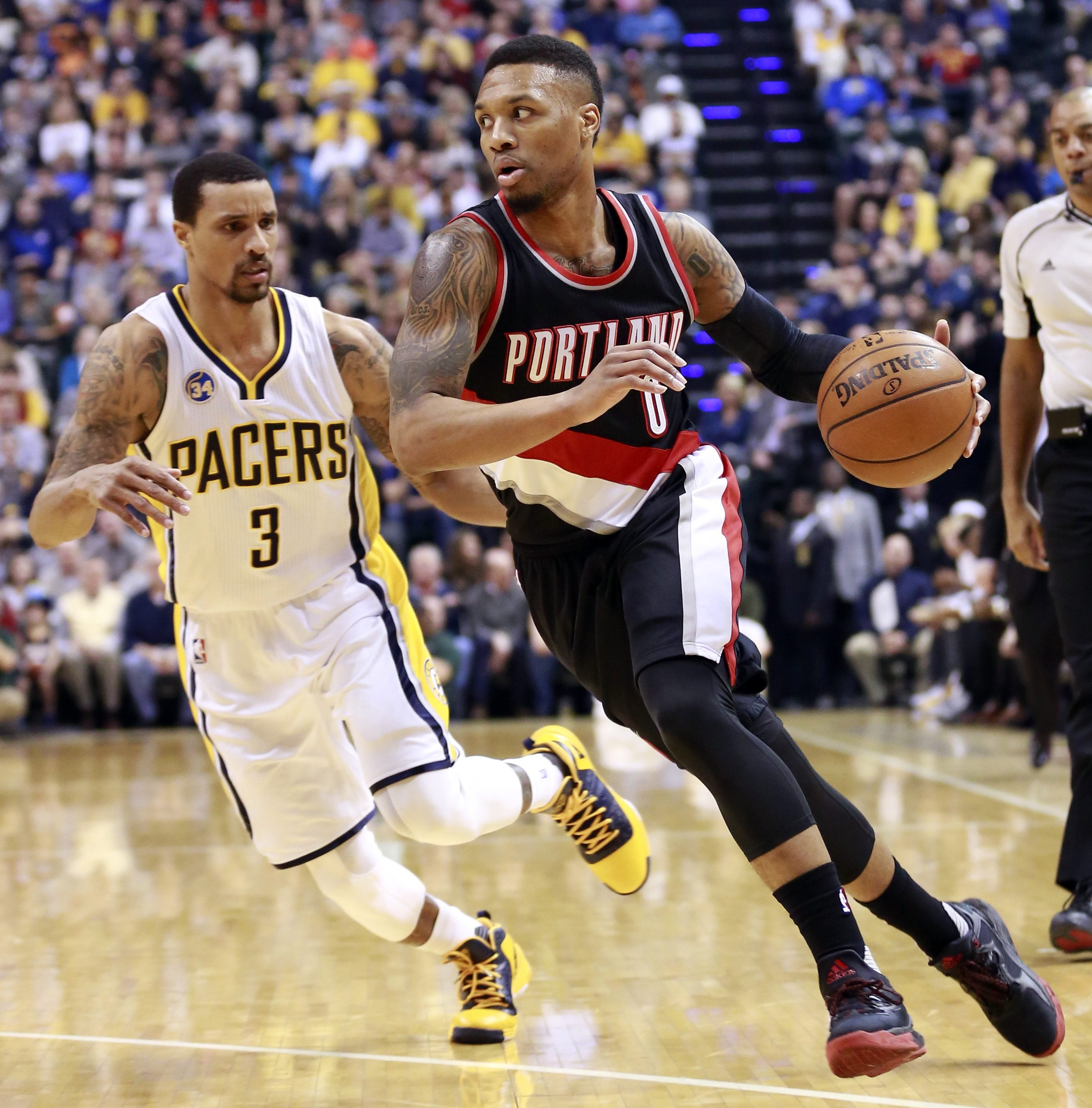Portland Trail Blazers guard Damian Lillard, right, gets past Indiana Pacers guard George Hill (3) in the first half of an NBA basketball game, Sunday, Feb. 28, 2016, in Indianapolis.