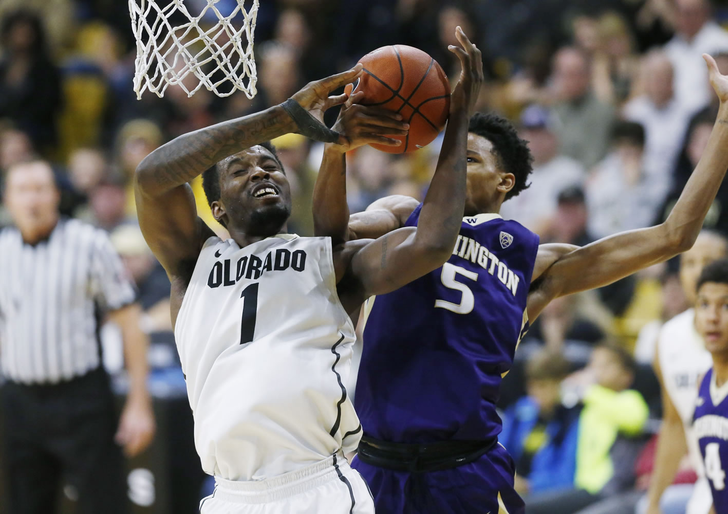 Colorado forward Wesley Gordon, left, fights for a rebound with Washington guard Dejounte Murray in the second half of an NCAA college basketball game Saturday, Feb. 13, 2016, in Boulder, Colo. Colorado won 81-80.