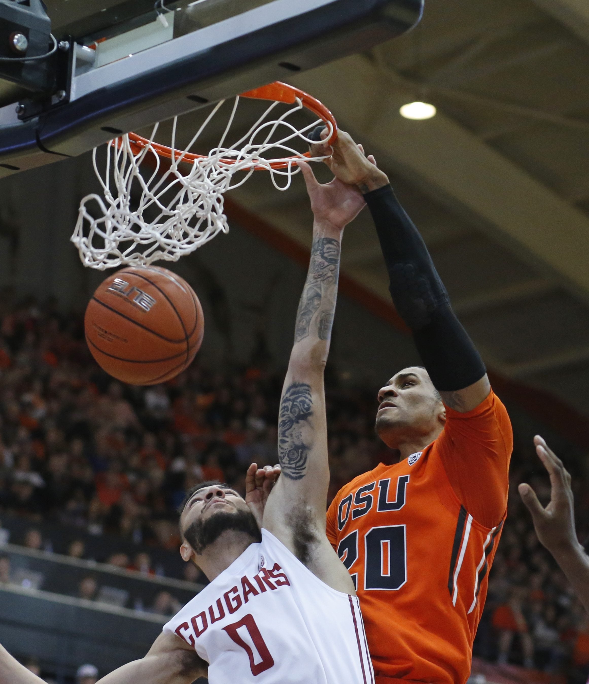 Oregon State's Gary Payton II, right, dunks over Washington State's Derrien King in the first half of an NCAA college basketball game in Corvallis, Ore., on Sunday, Feb. 28, 2016. (AP Photo/Timothy J.
