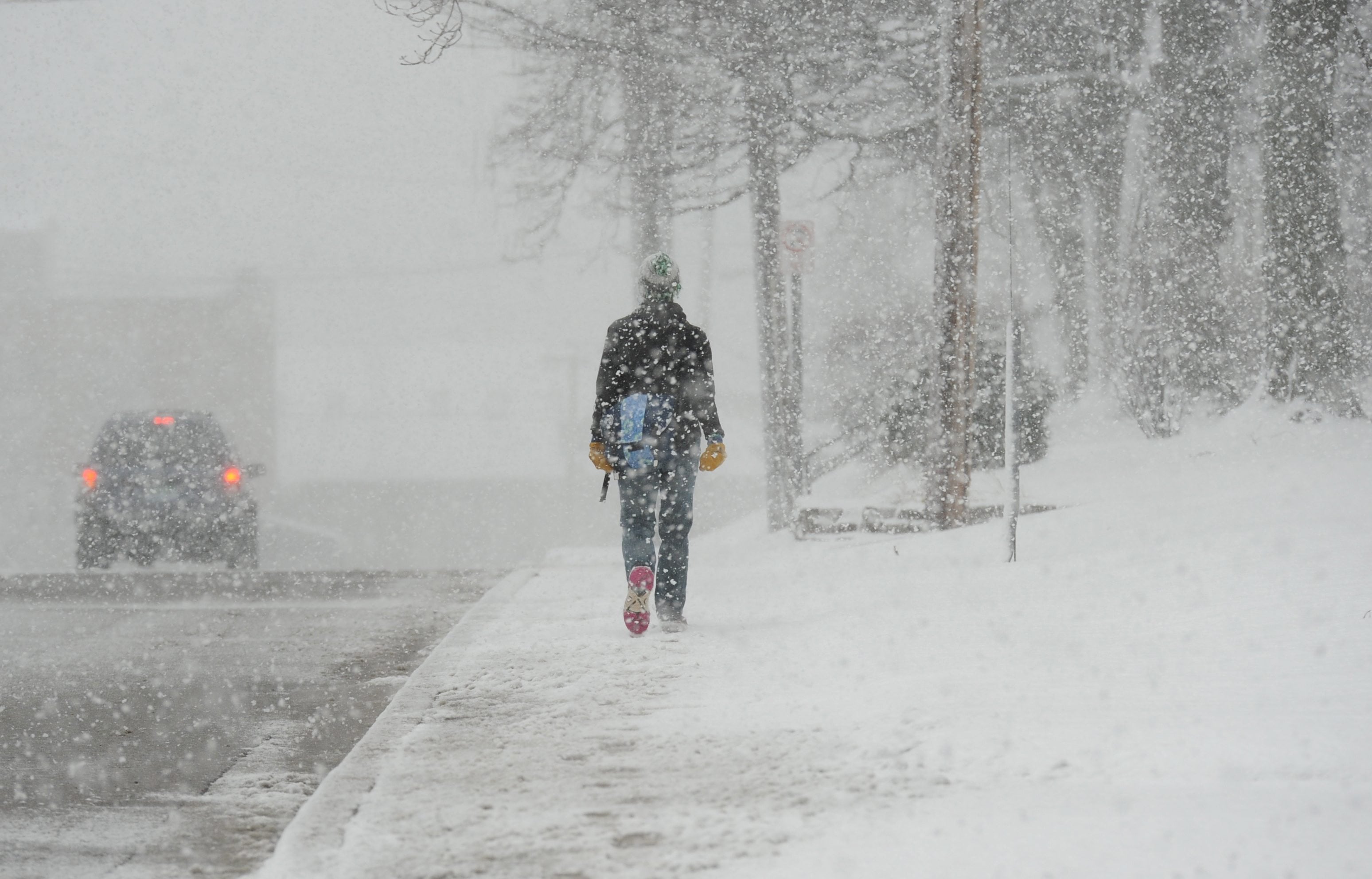 A pedestrian walks through heavy snowfall Wednesday in St. Joseph, Mich., Wednesday, Feb. 24, 2016. A winter storm moved across southwest Michigan Wednesday dumping several inches of snow in the area.