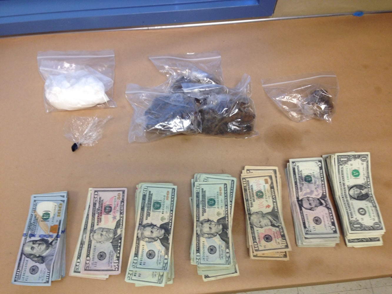 Drugs and cash located in Vancouver Thursday in a search connected to a drug dealing investigation. Officers recovered about 5 ounces of cocaine, 1 3/4 pounds of heroin and more than $7,000 in cash.