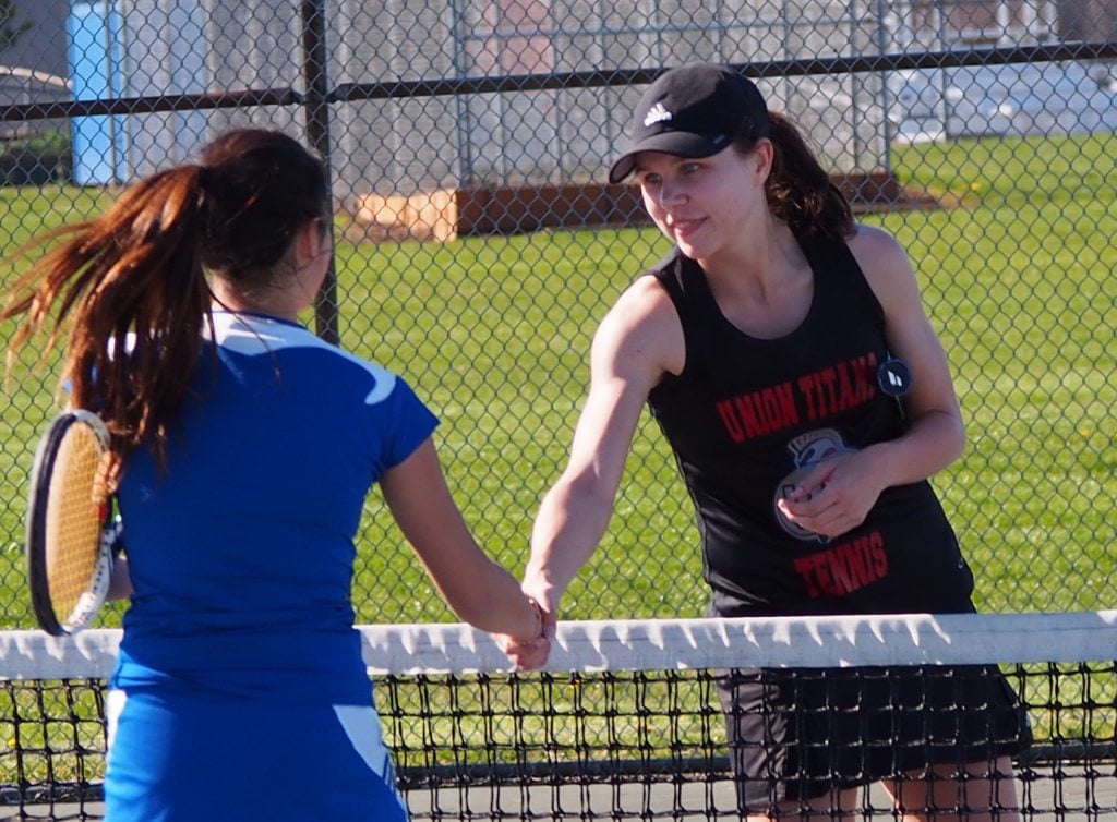 Union's McKenzie Schreiner shakes hands with Mountain View's Jeeyun Lee after winning at No. 2 singles 6-0, 6-0 on Wednesday, March 30, 2016.