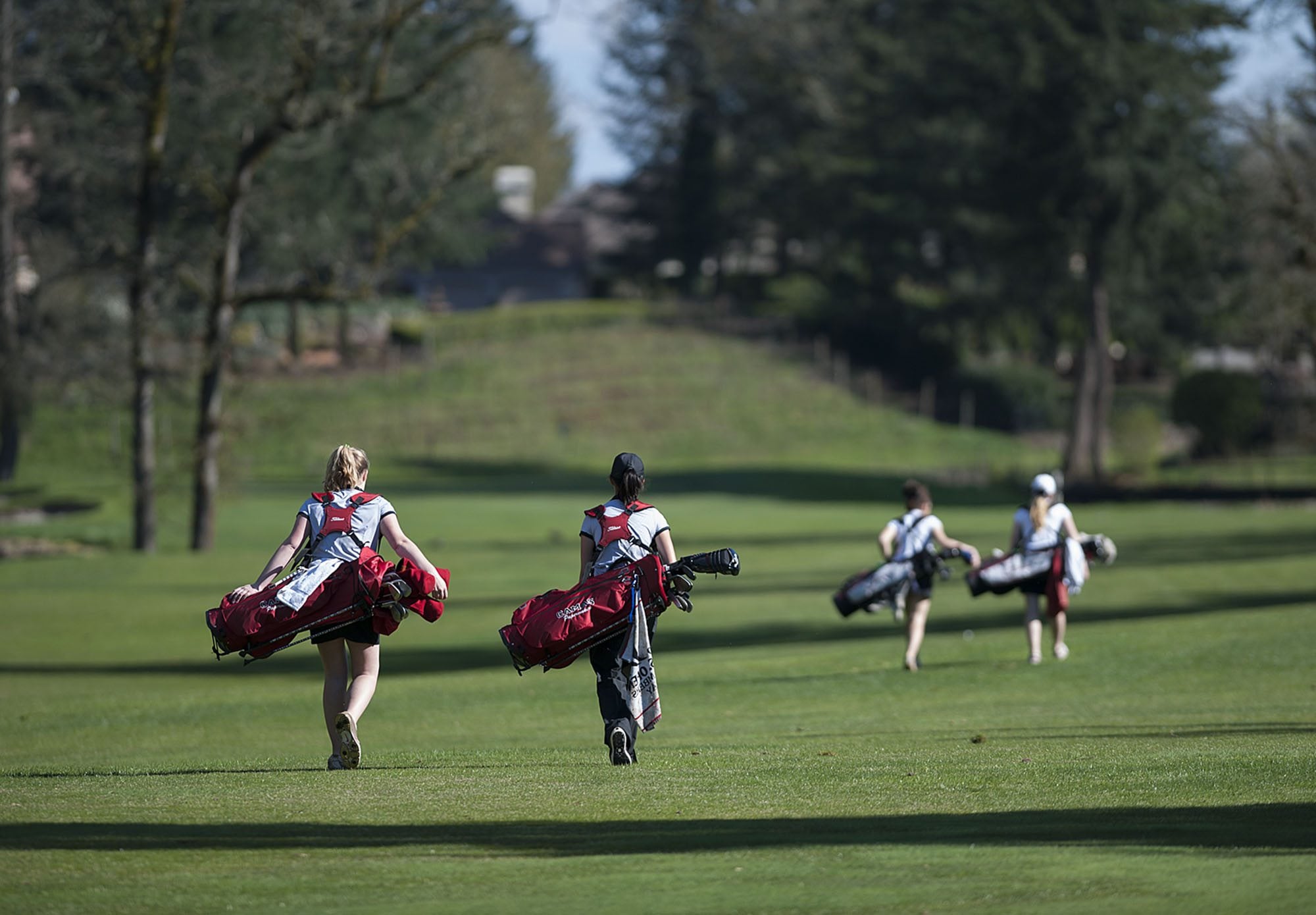 Camas' Elise Filuk and Connie Wang, from left, join Union's Reilly Whitlock and Taylor Hartley on the course Tuesday afternoon, March 29, 2016 at Camas Meadows Golf Course.