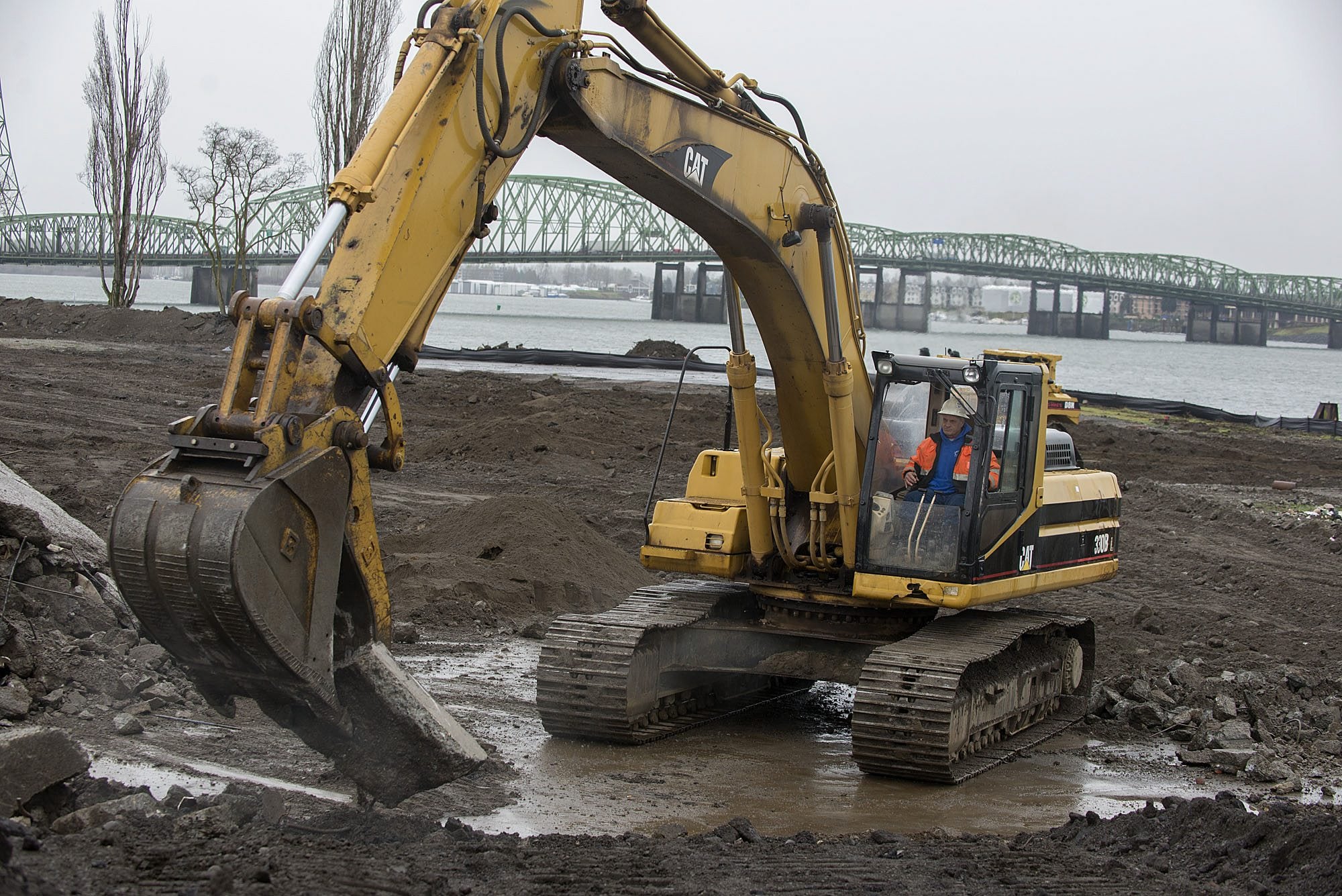 Stewart Brewer of Robertson &amp; Olson Construction runs an excavator Wednesday at the downtown Vancouver waterfront area, preparing the site for the city&#039;s 7-acre park and Renaissance Trail extension.