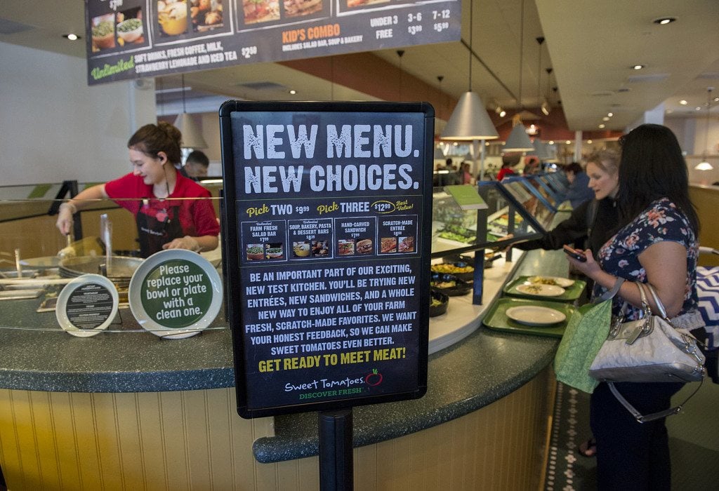 A sign notifies Sweet Tomatoes guests in 2016 that the Vancouver restaurant is a test site for adding meat items to its menu.