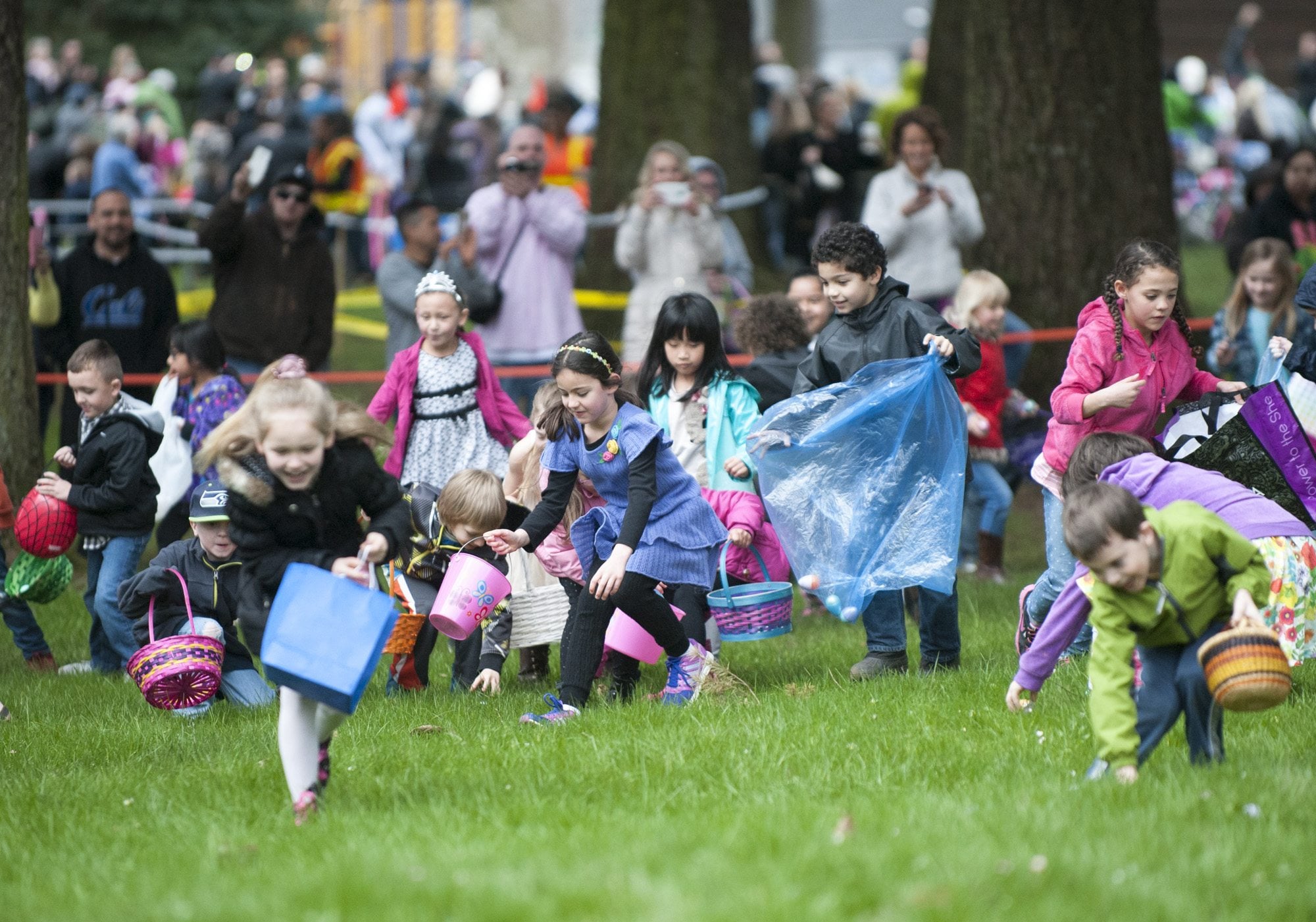 Children hurry to collect plastic eggs Sunday at an Easter egg hunt at Crown Park in Camas. About 2,000 people attended the free event.