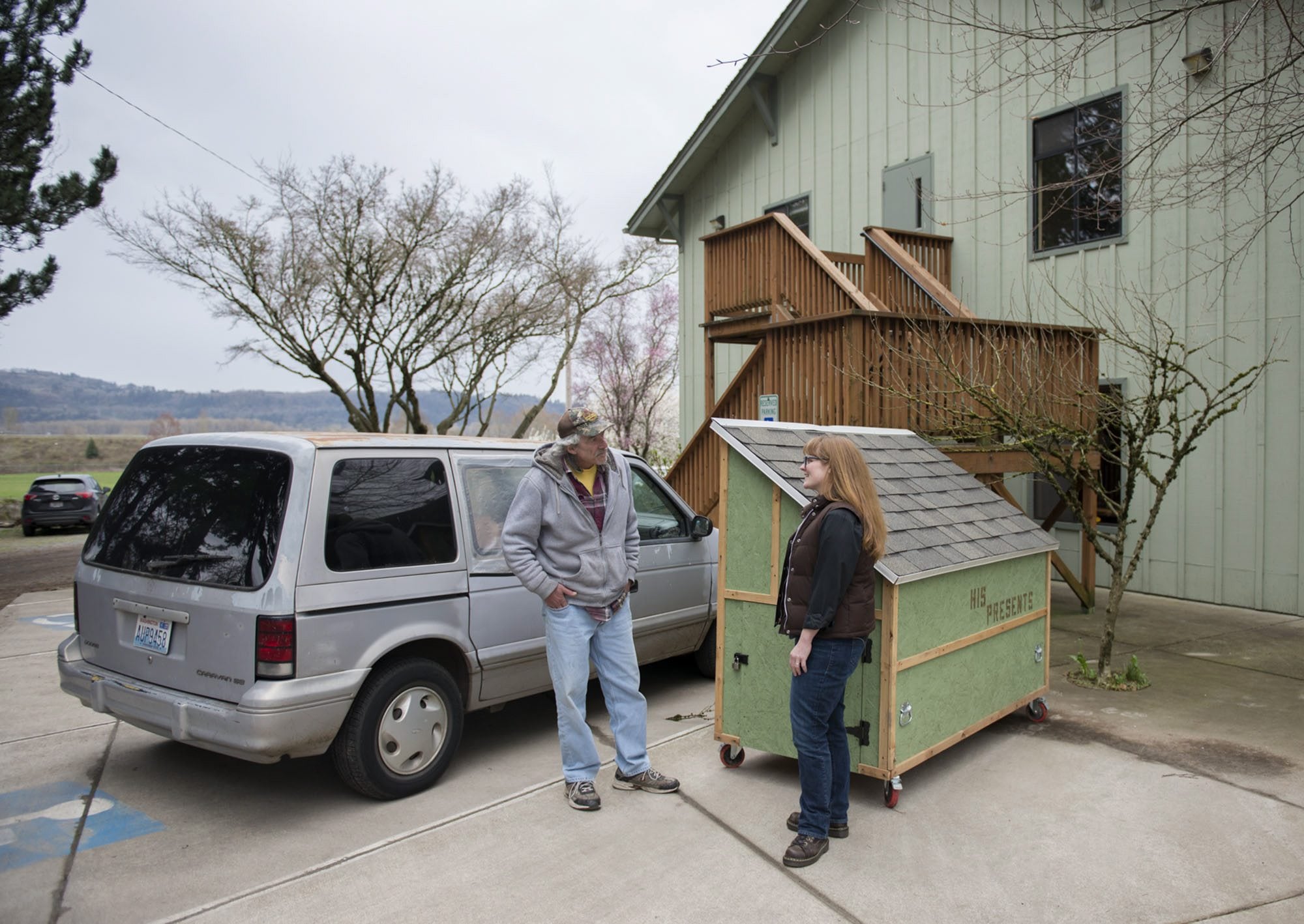 Cory Soderberg, left, talks with the Rev. Jessie Smith near his van and a hut for the homeless in the parking lot at St. Anne&#039;s Episcopal Church.